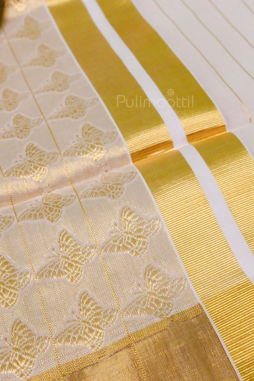 Kerala kasavu saree displayed outdoors in soft natural light, highlighting its golden border and intricate butterfly designs.