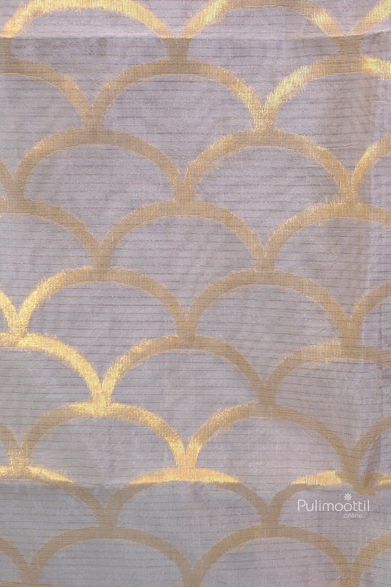 Detailed view of golden scallop motif design on ash-colored Tussar silk fabric