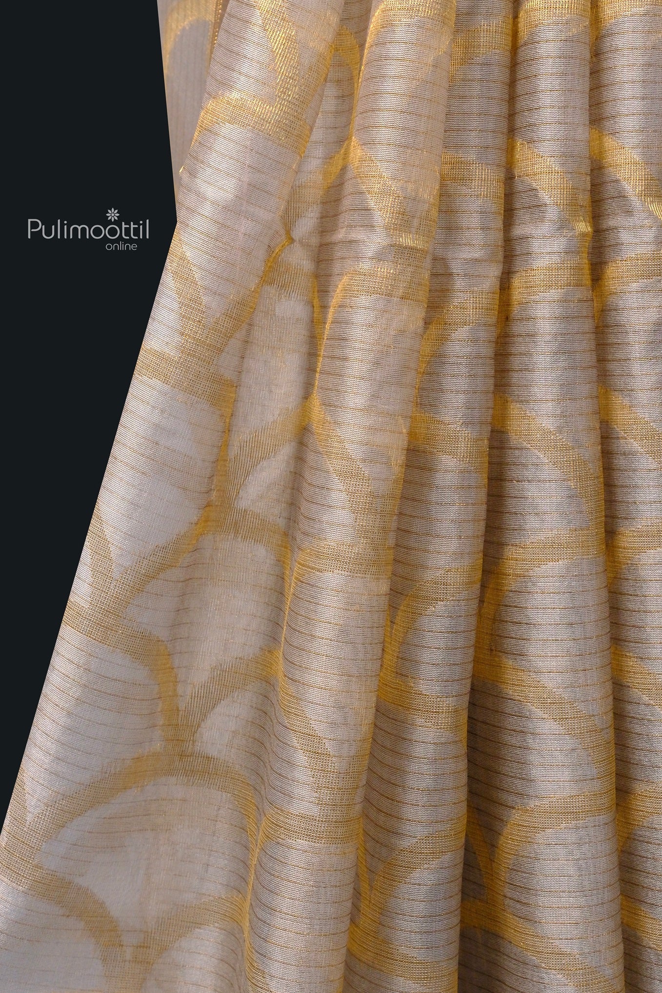 Flowing fabric of ash-colored Tussar silk saree with bold golden scallop motifs on soft woven texture