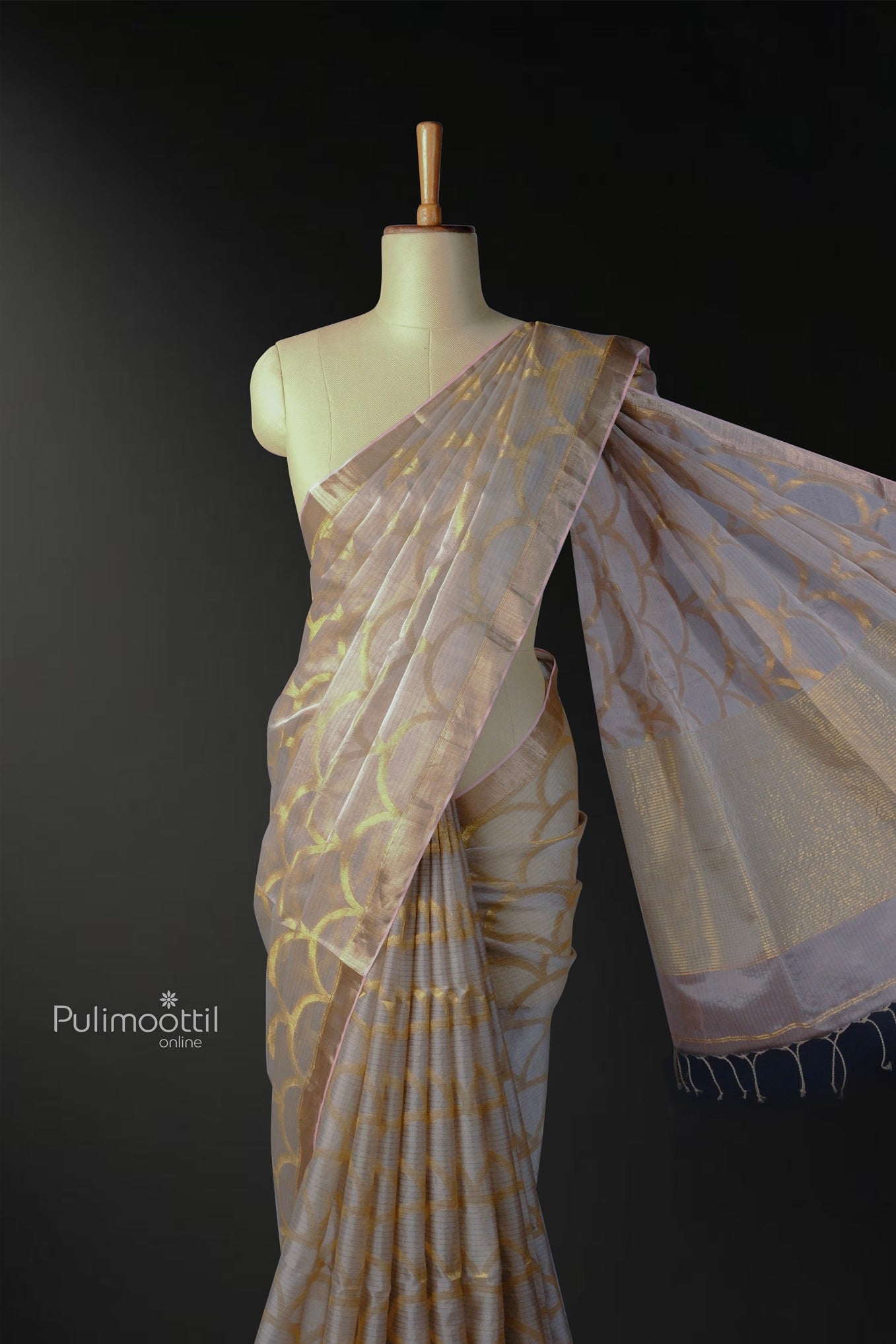 Mannequin draped in an elegant ash-colored pure Tussar silk saree with golden scallop motifs and a shimmering pallu