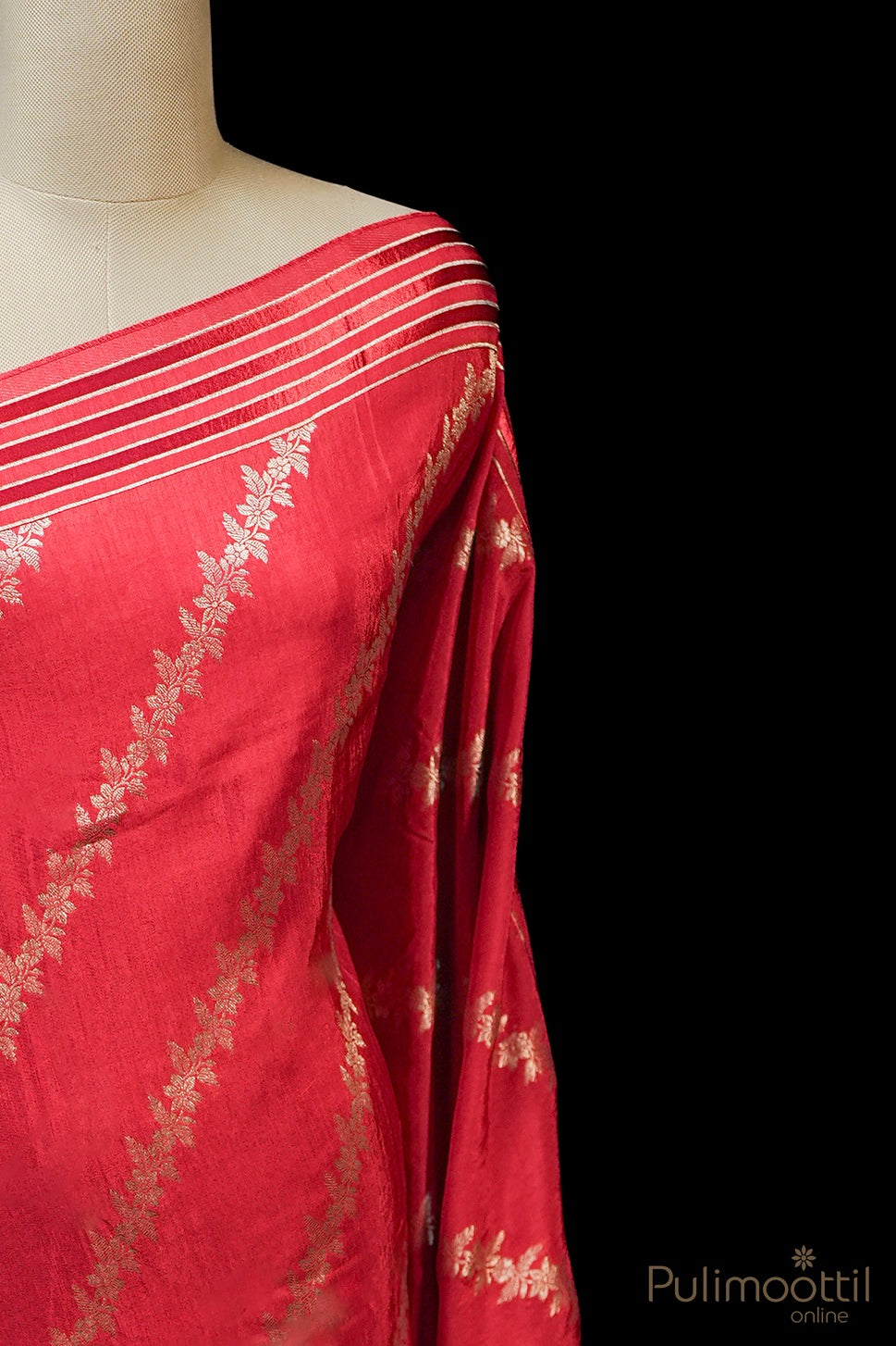 Red saree border with gold floral embroidery and striped detailing, displayed on mannequin