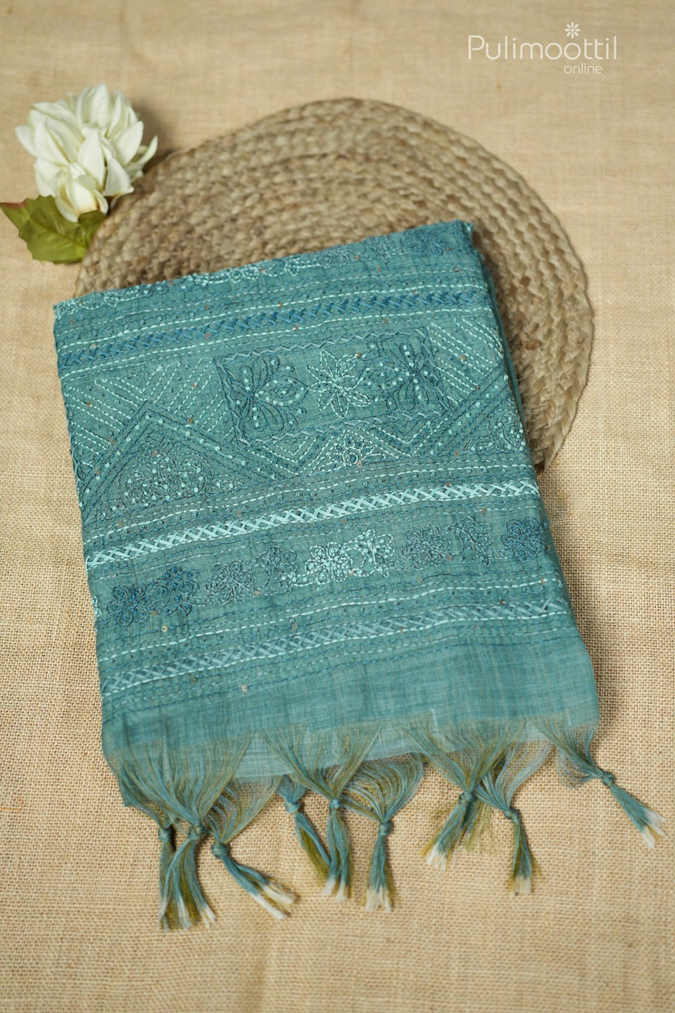Light teal green-colored hand-embroidered semi linen saree