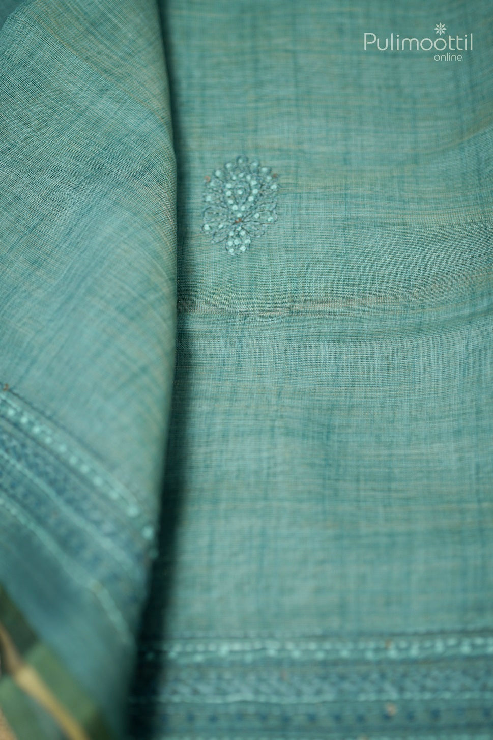 Light teal green-colored hand-embroidered semi linen saree