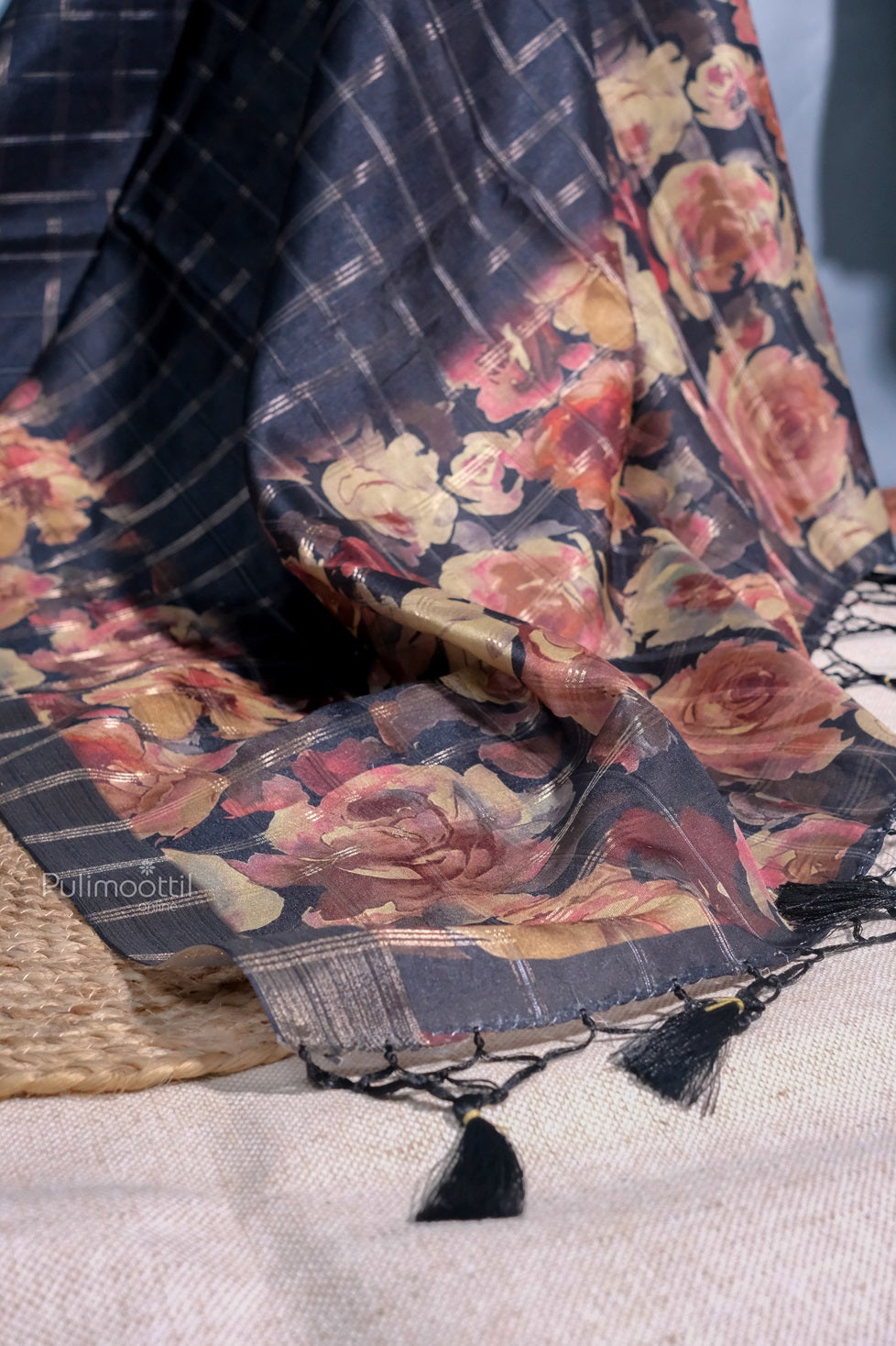 Side view of a model wearing a black semi tussar silk saree with a rich, flowing drape and minimalistic design.