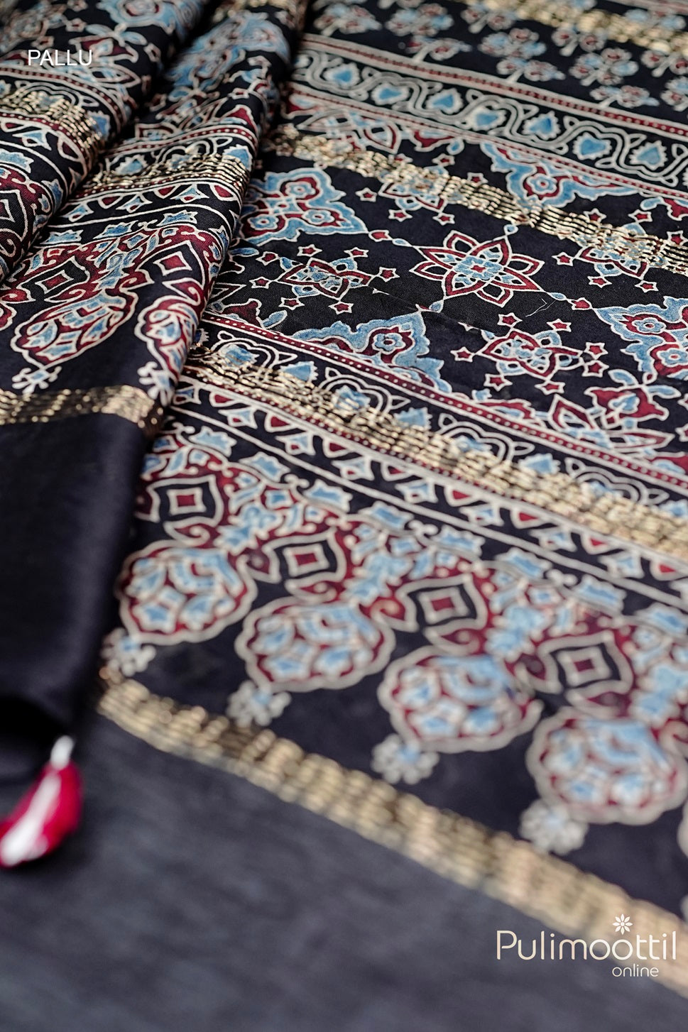 Chandheri Silk Saree pallu with intricate floral design in black, adorned with zari border and rich detailing in gold and blue.