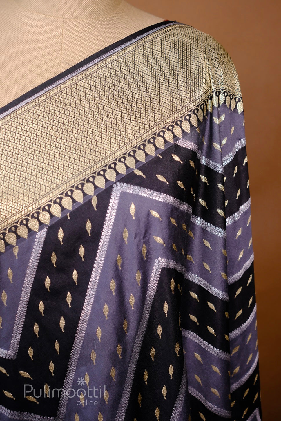 Draped navy-blue silk saree with lavender chevron and gold butta motifs, highlighted by an intricately woven gold-checked zari border.
