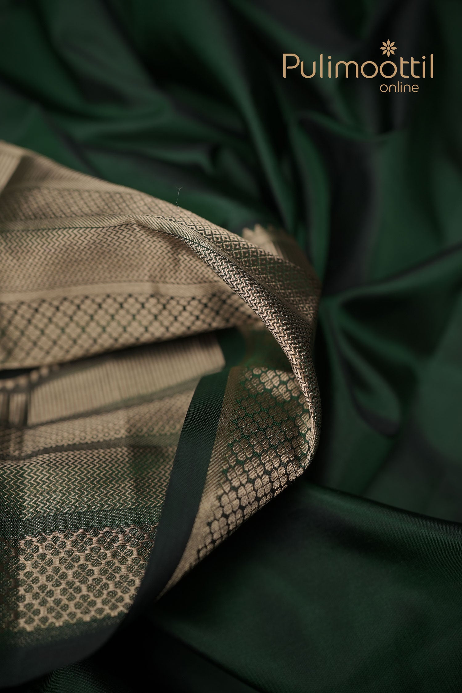 Bottle‑green Kanchipuram silk saree with golden zari stripes and small butta motifs