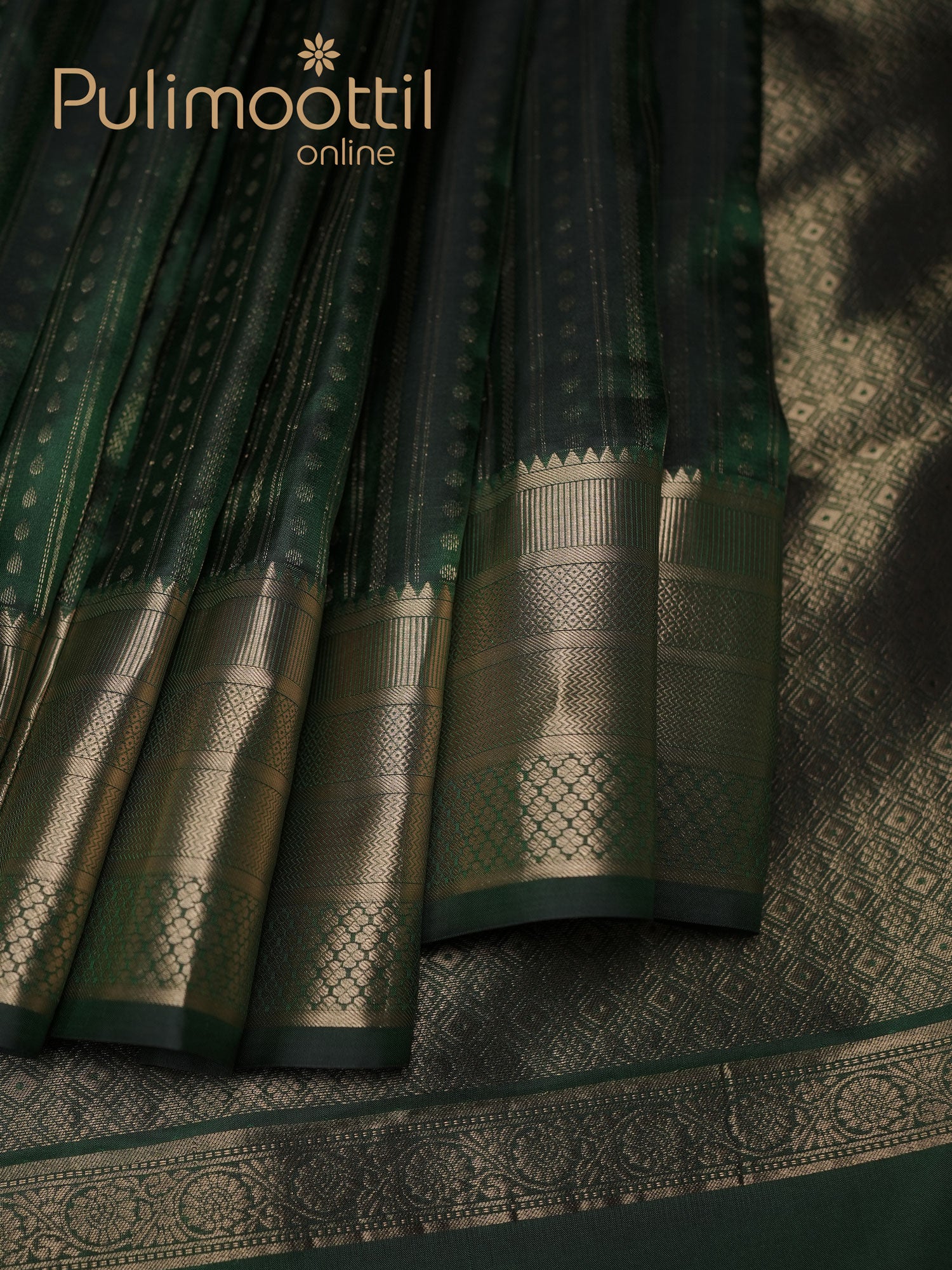 Bottle-green Kanchipuram silk saree pleated with golden zari border and delicate butta motifs