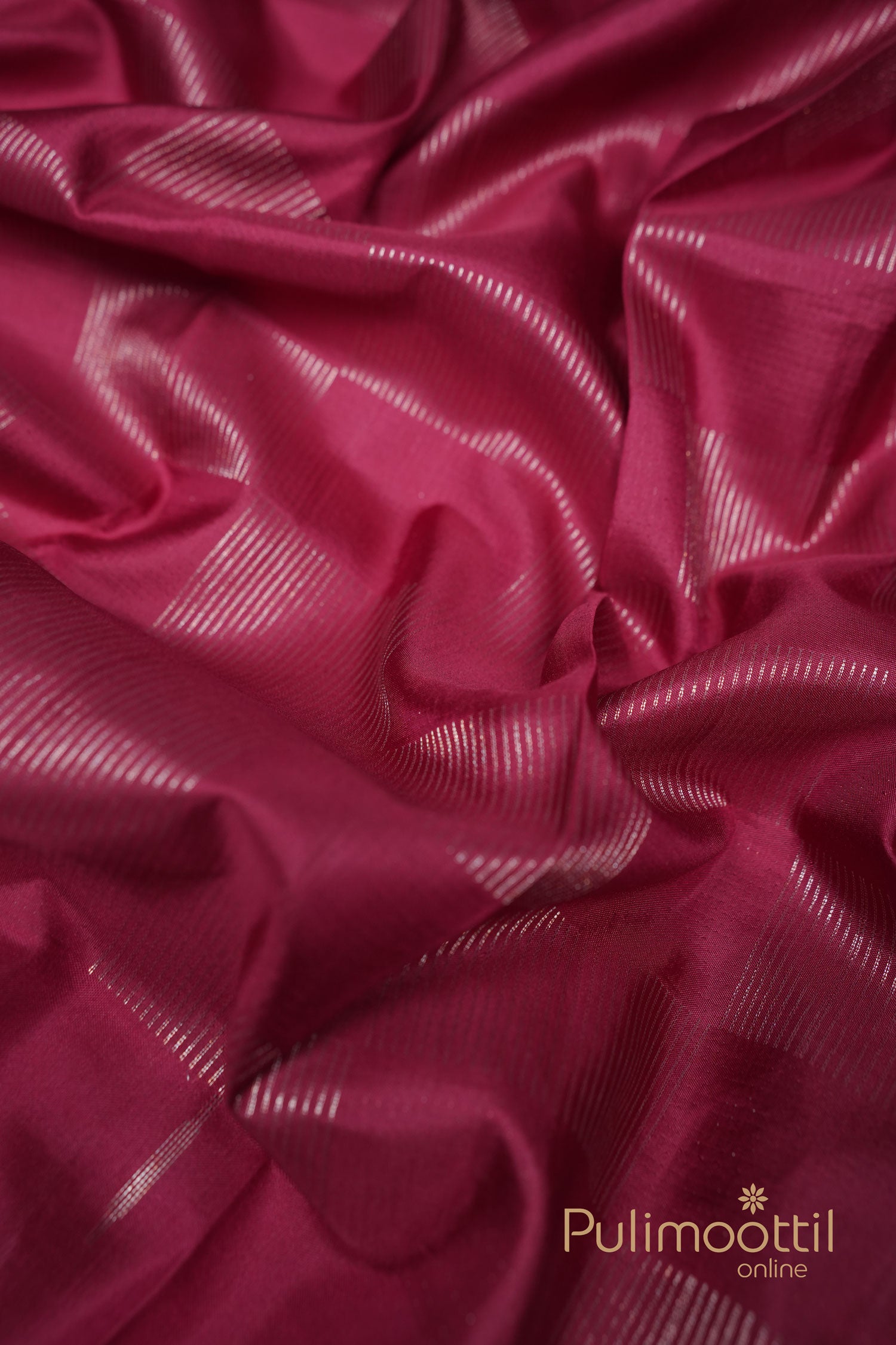 Soft maroon Kanchipuram silk saree with delicate silver zari checkered pattern, displayed in elegant folds – ideal for weddings and traditional functions.