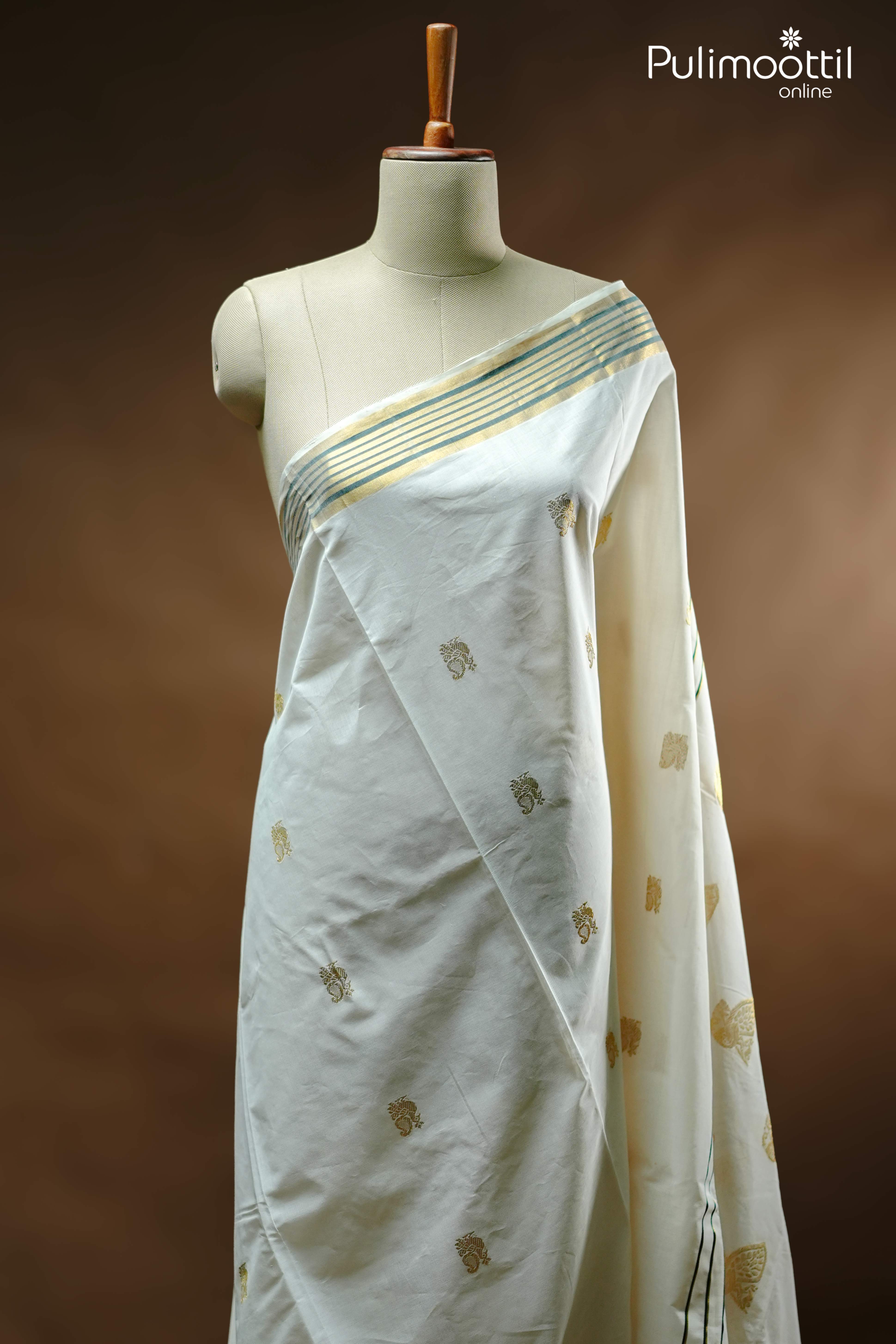 Cream colour Kerala set saree with golden zari peacock motifs on body, golden and green striped tissue border, displayed on mannequin for traditional festive wear.