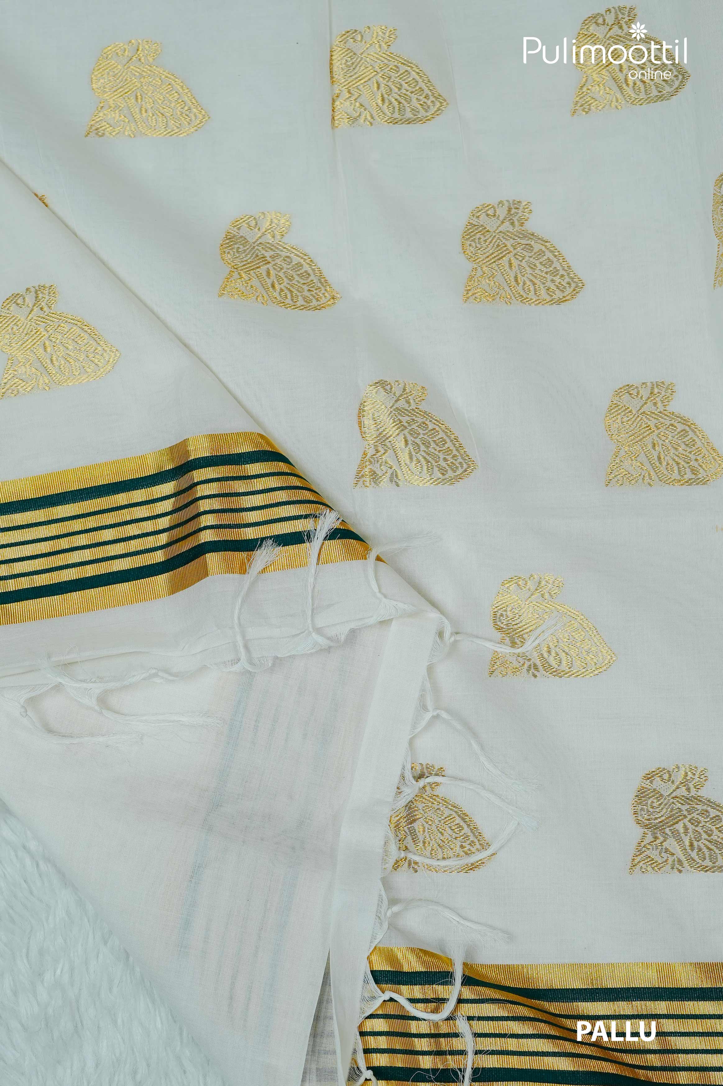 Pallu of cream colour Kerala set saree with golden zari peacock motifs, golden-green striped tissue border, and white tassels, displayed on soft white background.