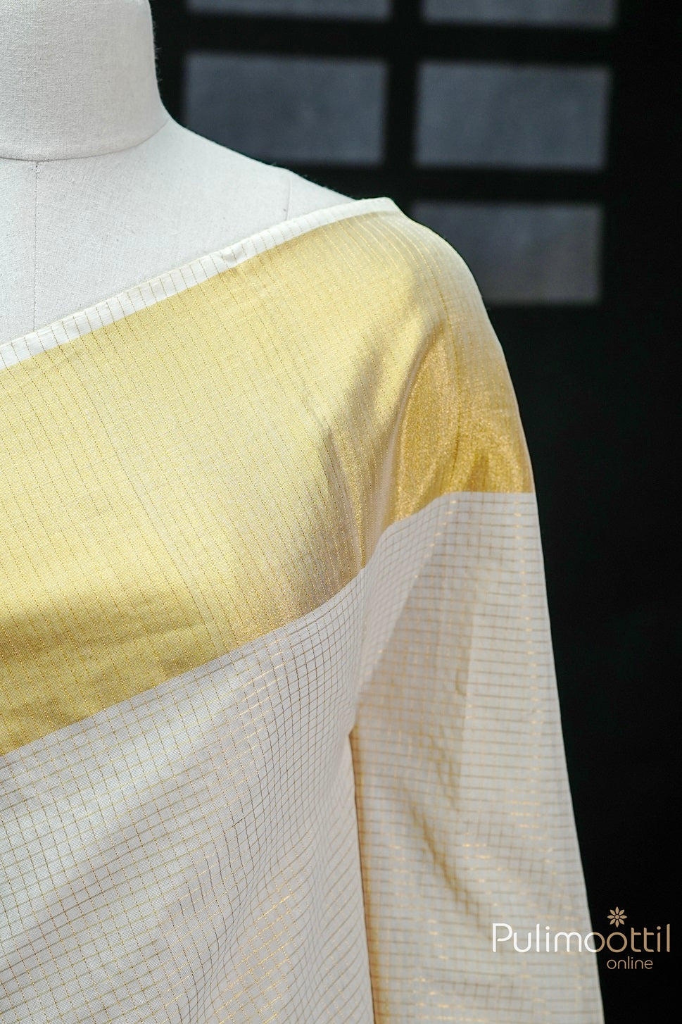 Close-up of Cream Colour Kerala Traditional Handloom Saree with golden zari check design and golden tissue border.