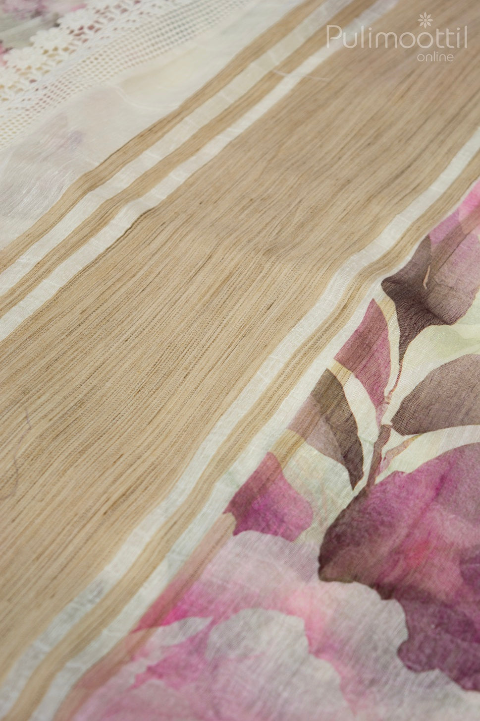 Close-up of cream linen saree pallu with beige woven stripes and subtle pink floral print, finished with delicate Crosia lace on the border.
