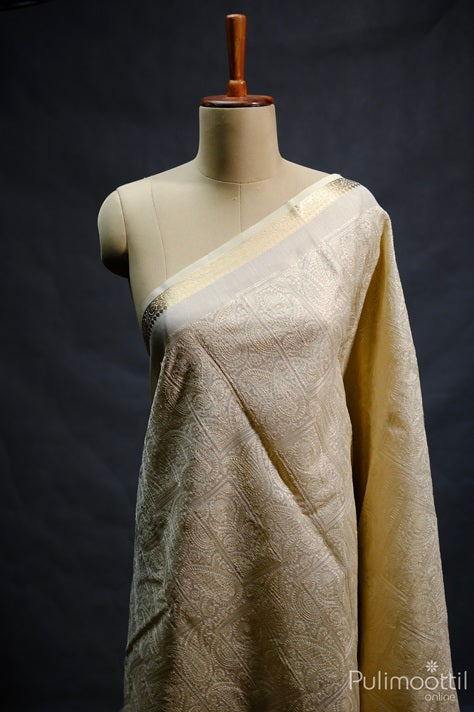 Cream Colour Net Cotta Saree. Mango Floral Thread Design With Golden Zari Creeper Design Border