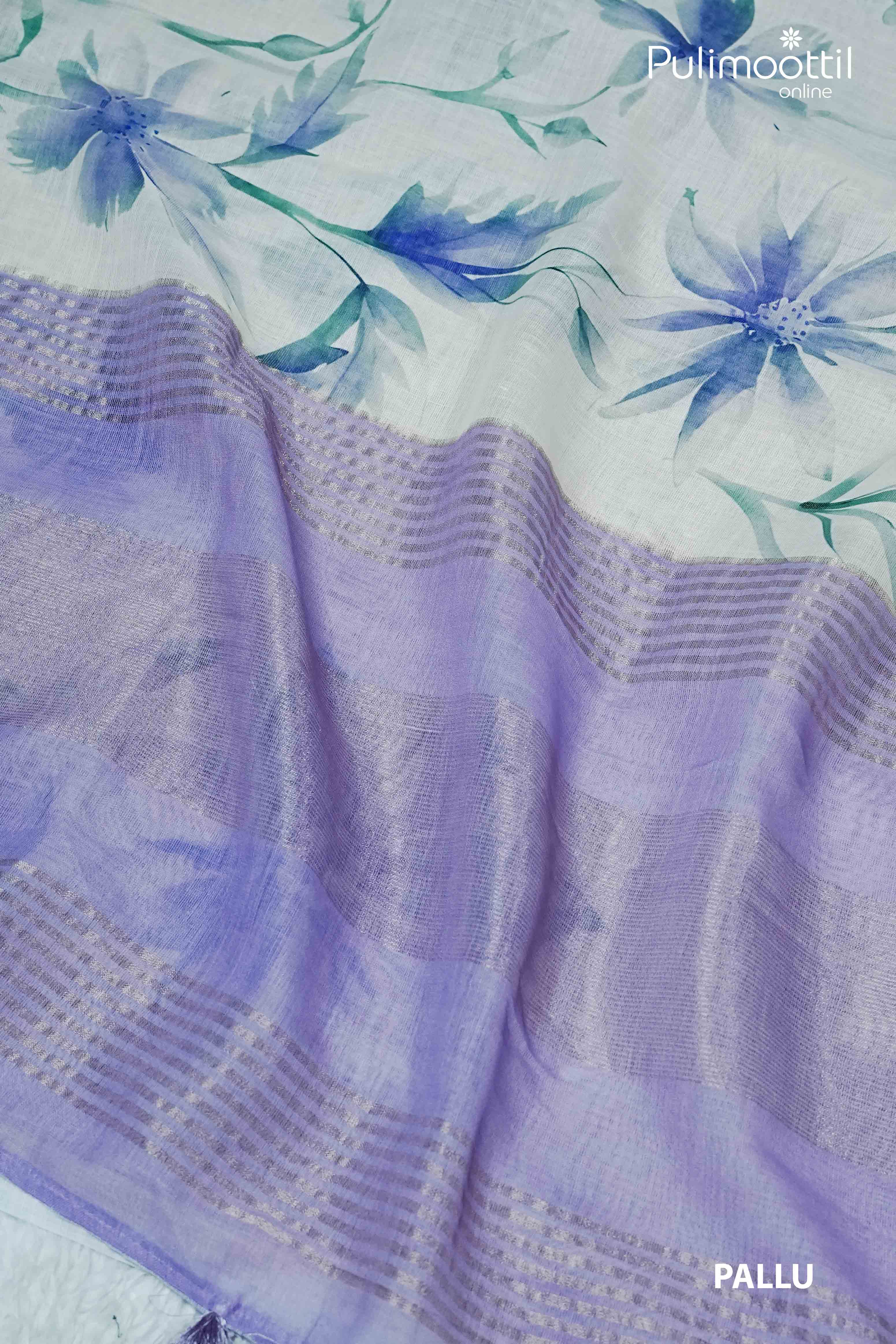 Cream semi linen saree with blue floral prints and a contrast lavender pallu featuring zari lines and tassel detailing – Pulimoottil Online