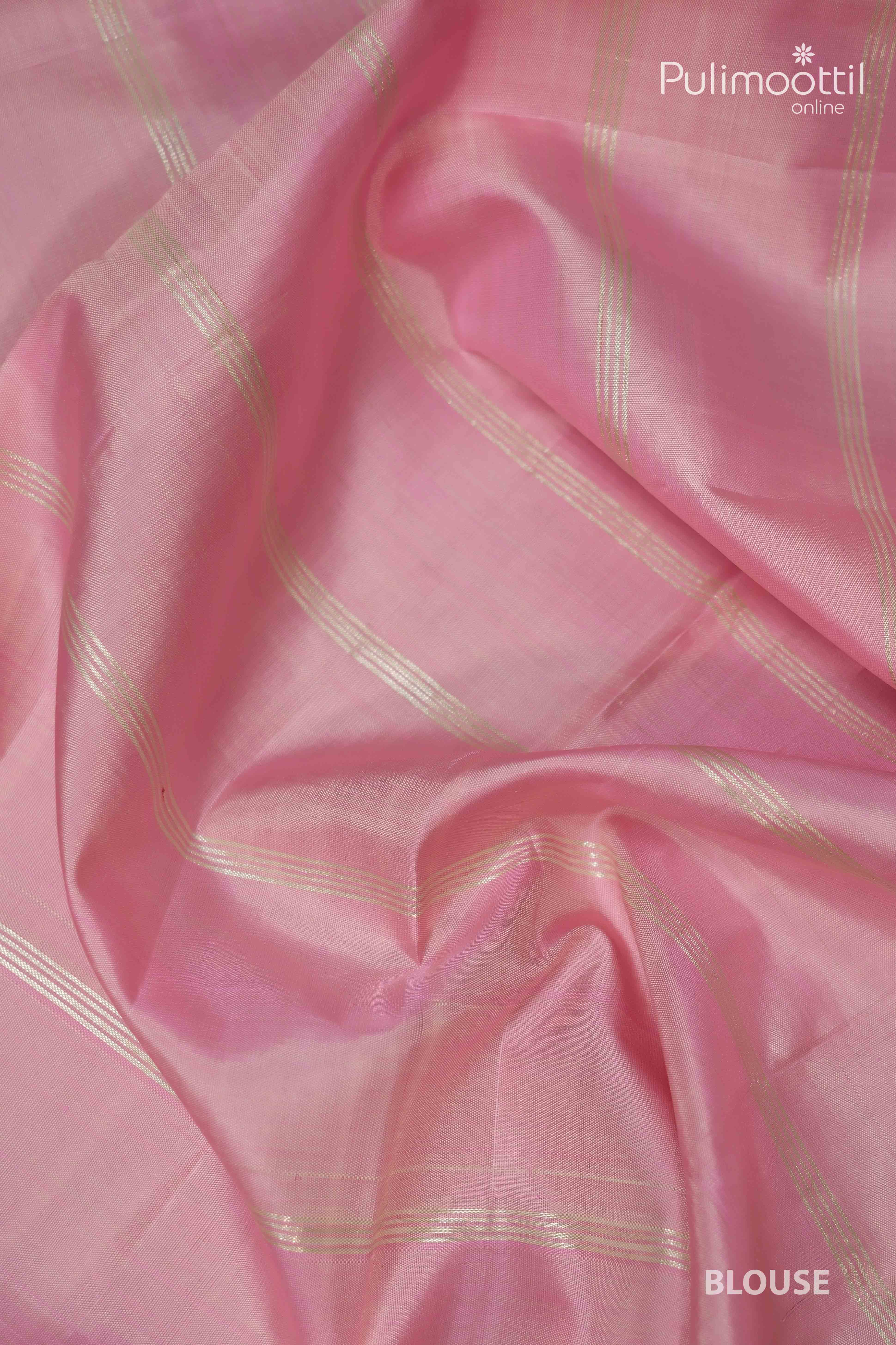 Pink blouse piece of pure Kanchipuram silk saree with delicate silver checked design, fabric detail shown up close.