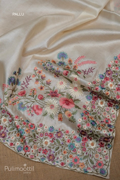 Pallu of cream colour pure Tussar silk saree featuring dense multicolour floral thread embroidery with intricate border design, showcasing traditional elegance.