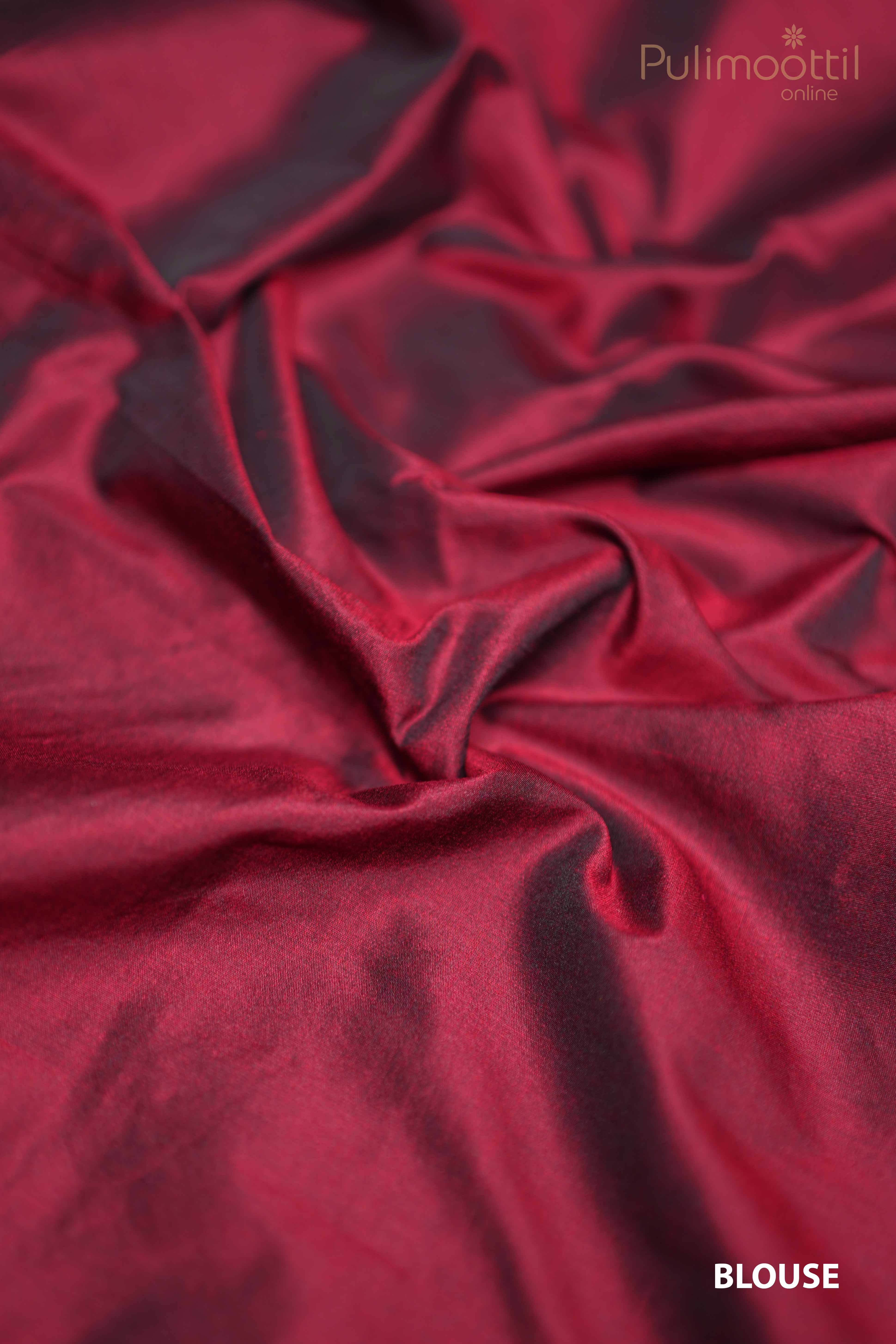 Unstitched maroon silk blouse fabric with smooth, lustrous texture — styled to match cream organza saree.