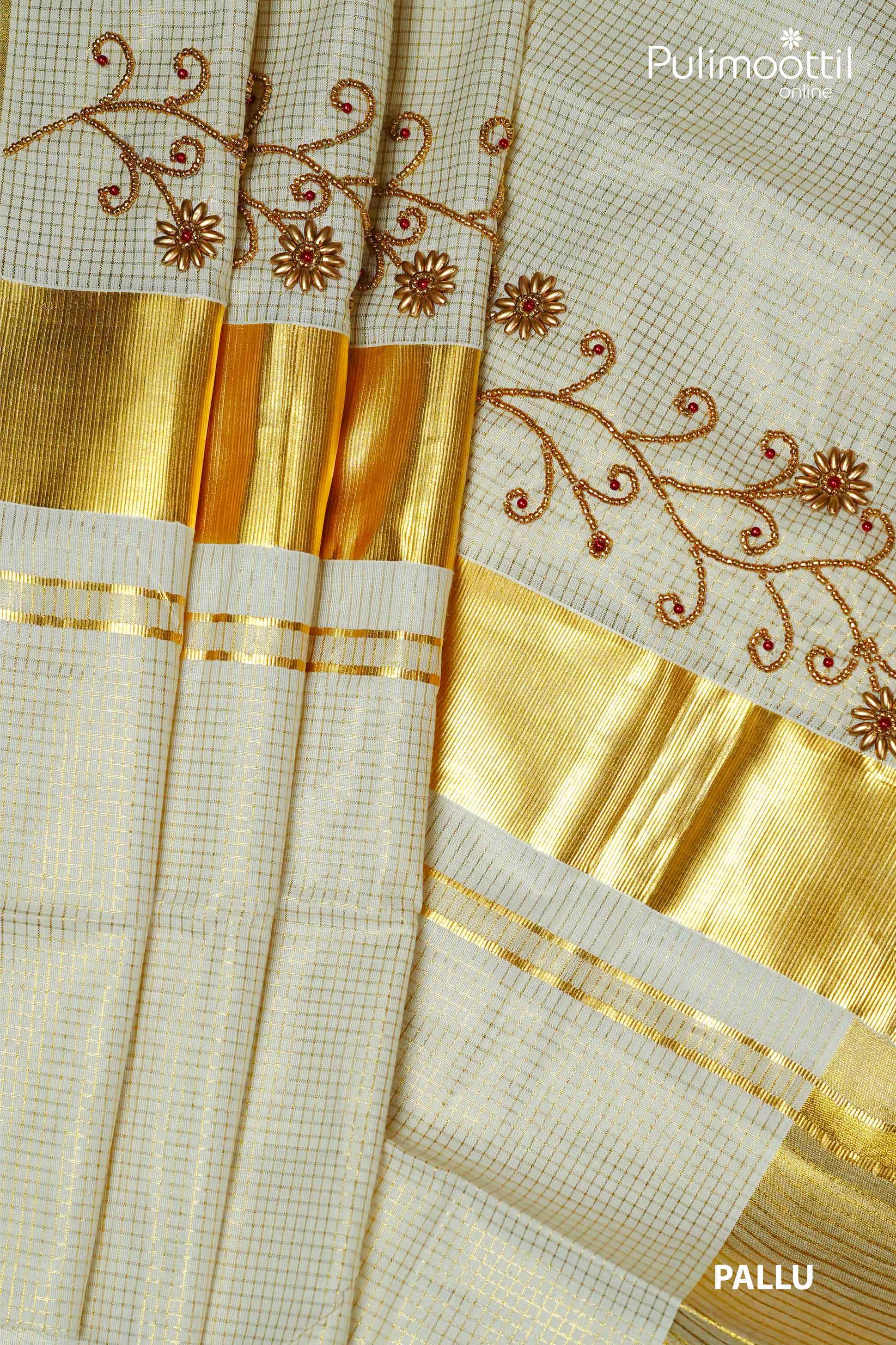 Close-up of cream Kerala set saree pallu with golden zari border, bead floral embroidery, and grid check pattern