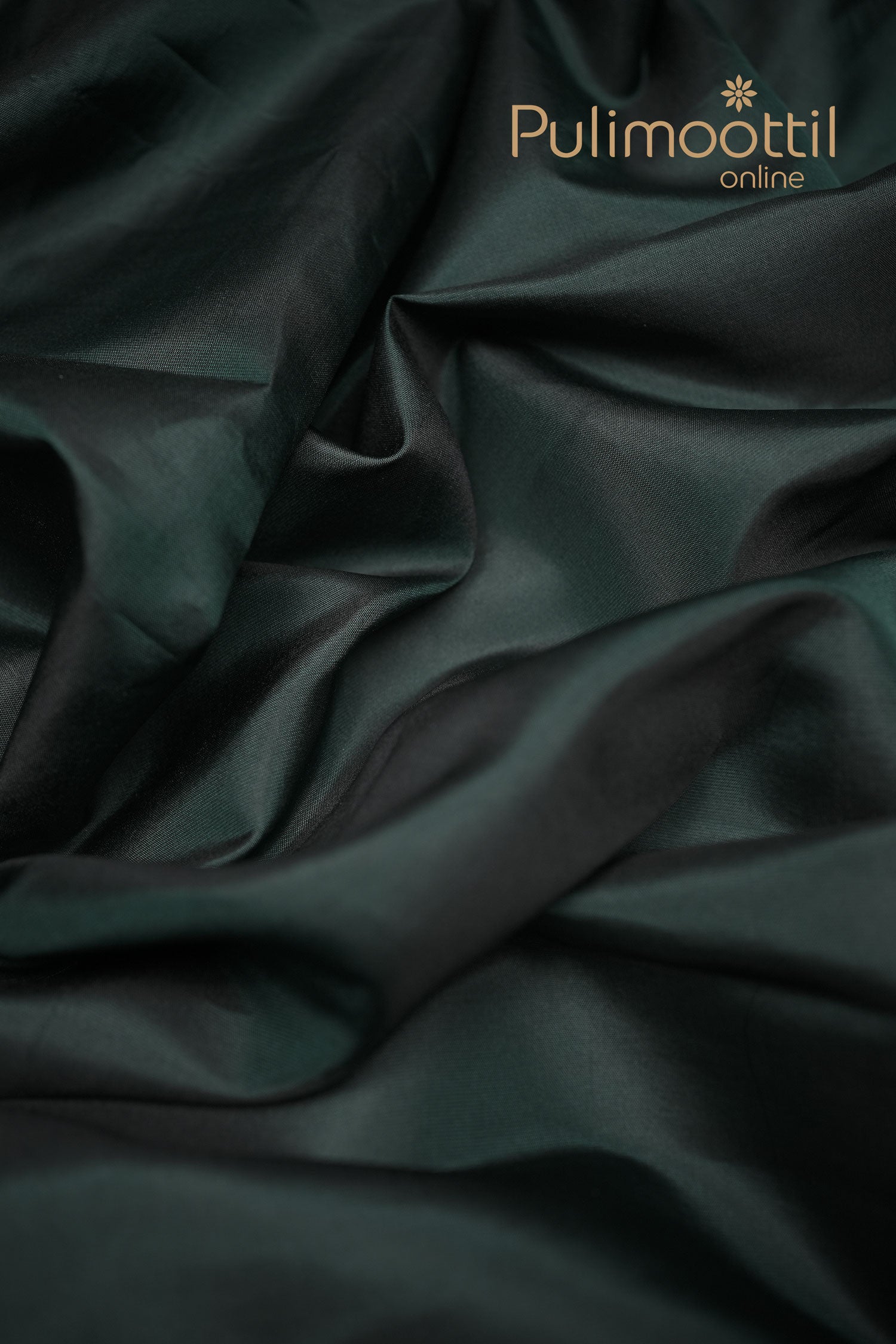 Crocodile green silk blouse piece with smooth drape and subtle sheen, highlighting its rich texture and plain deep green color.