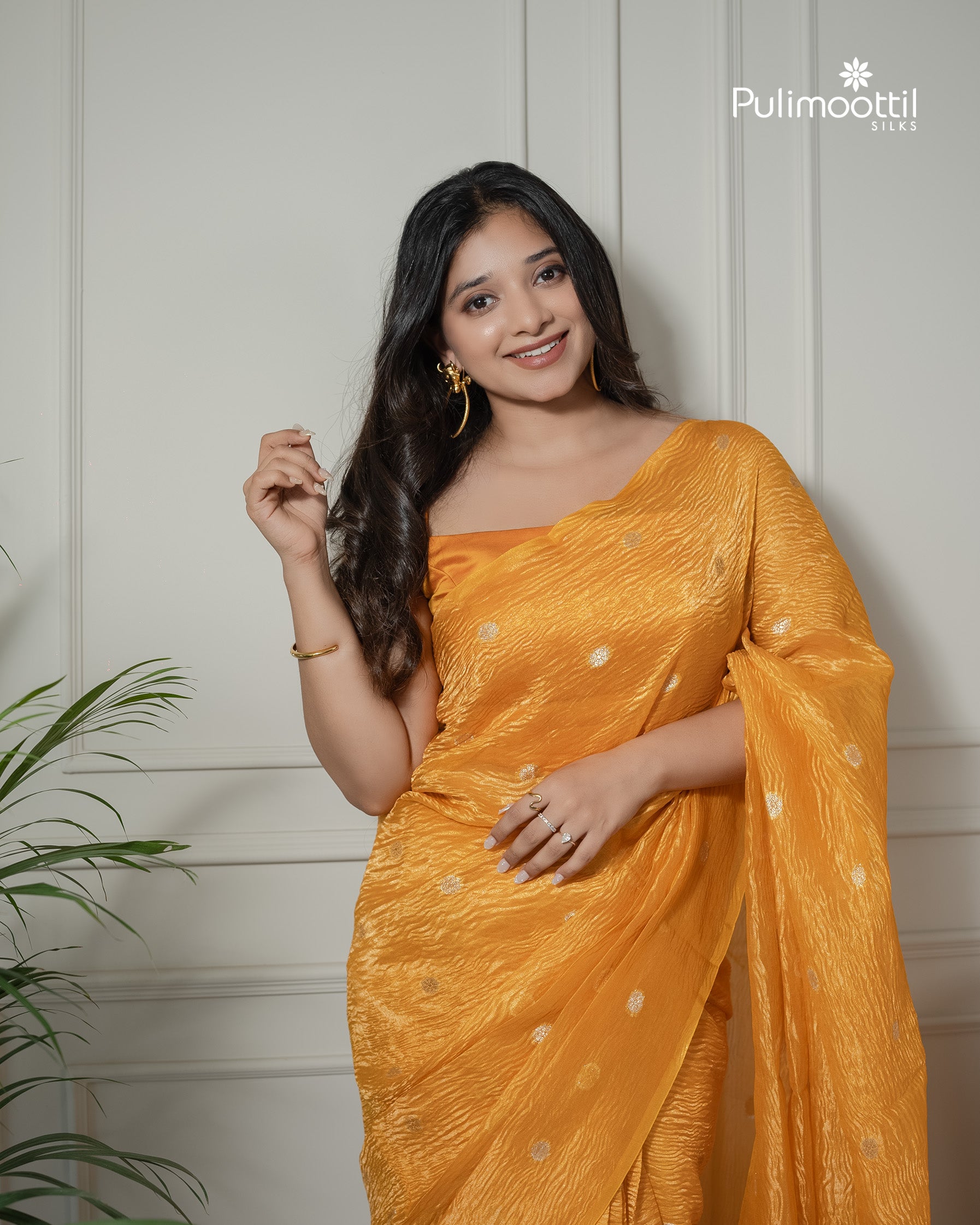 Yellow color crushed Organza saree.