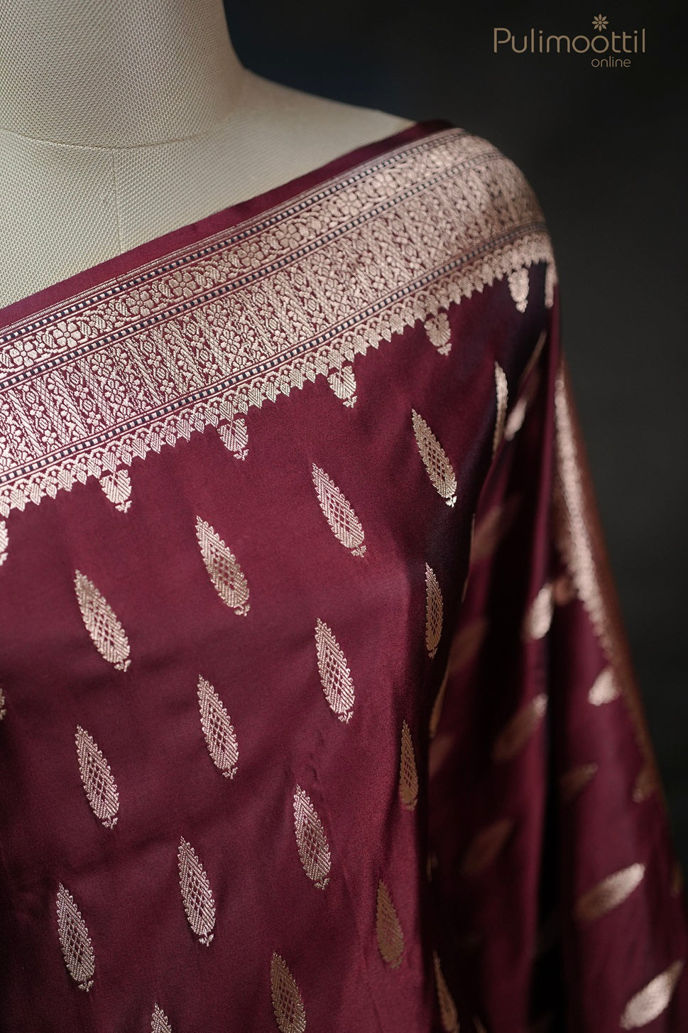 Full view of maroon Mashru silk Banarasi saree with golden buttas, designer border, and contrast brocade blouse, elegant bridal saree and party wear from Pulimoottil Silks.