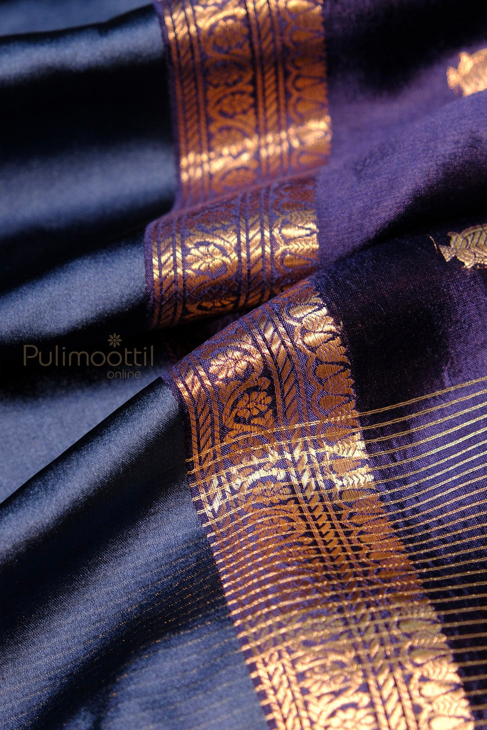 Luxurious mango silk saree in navy and purple, featuring golden zari floral patterns on pallu and rich woven textures.