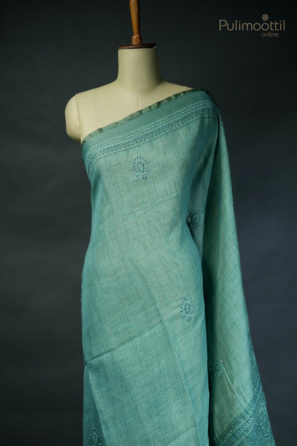 Light teal green-colored hand-embroidered semi linen saree