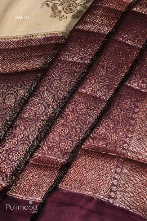 Pallu of an ecru‑beige Chiniya Banarasi silk saree with intricately woven maroon‑purple geometric and floral zari patterns