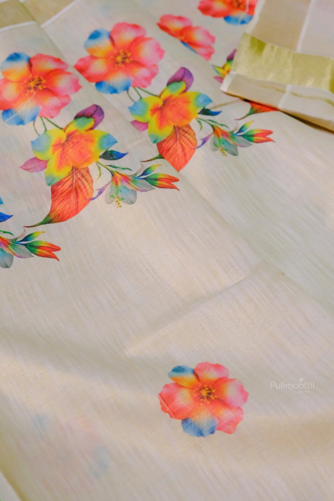 Traditional Kerala saree featuring vibrant floral motifs and shimmering golden zari border