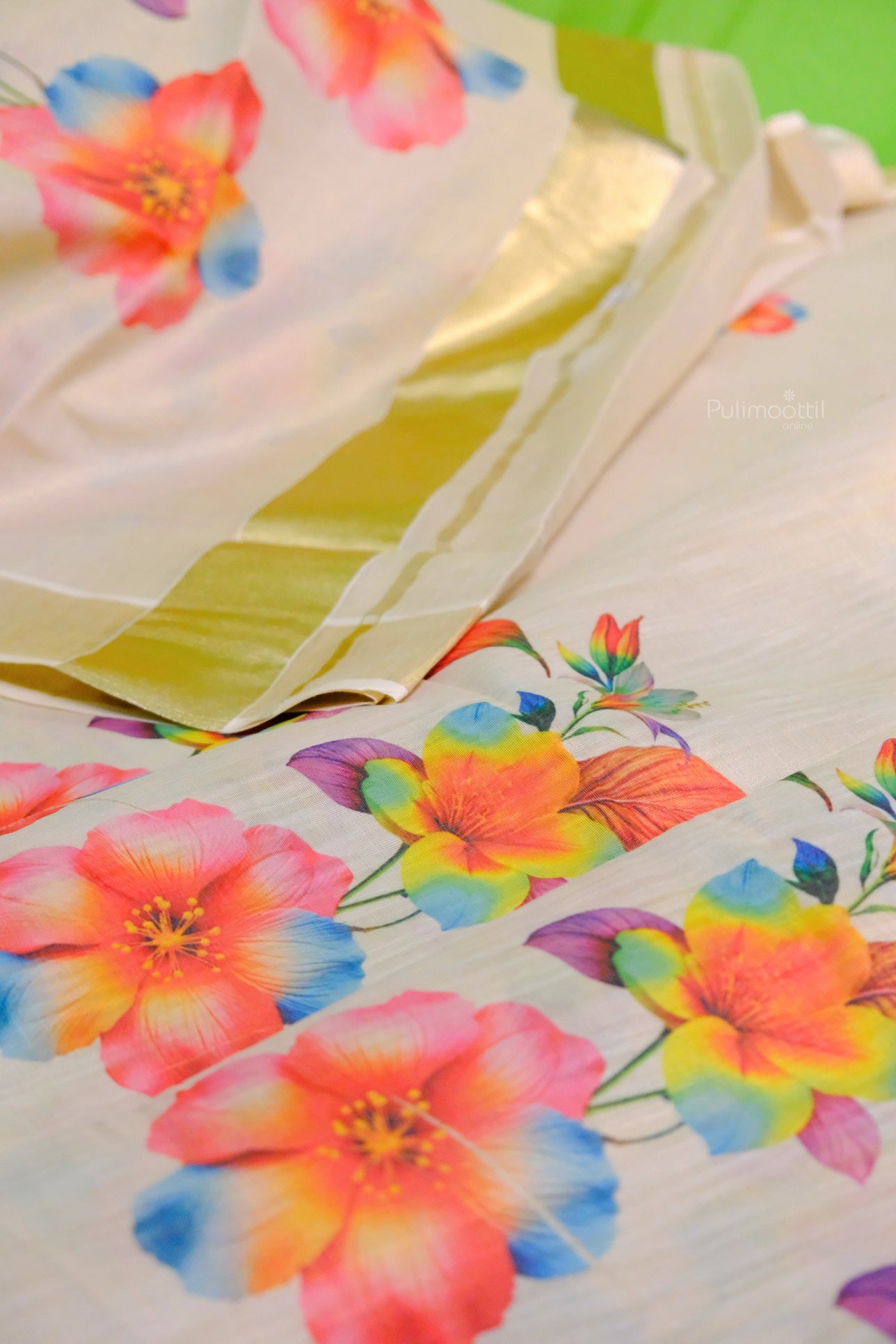 Kerala tissue saree with large multicolor flowers and rich golden pallu on off-white fabric