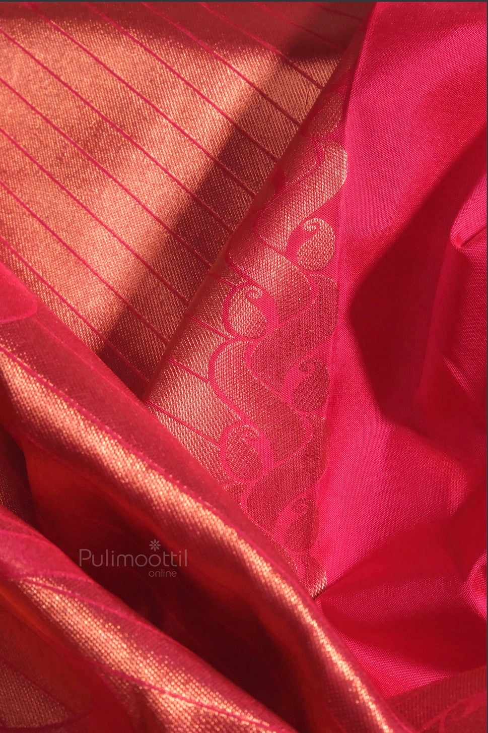 Side profile of a woman wearing a red bridal saree, highlighting the traditional border and pallu drape over the shoulder.