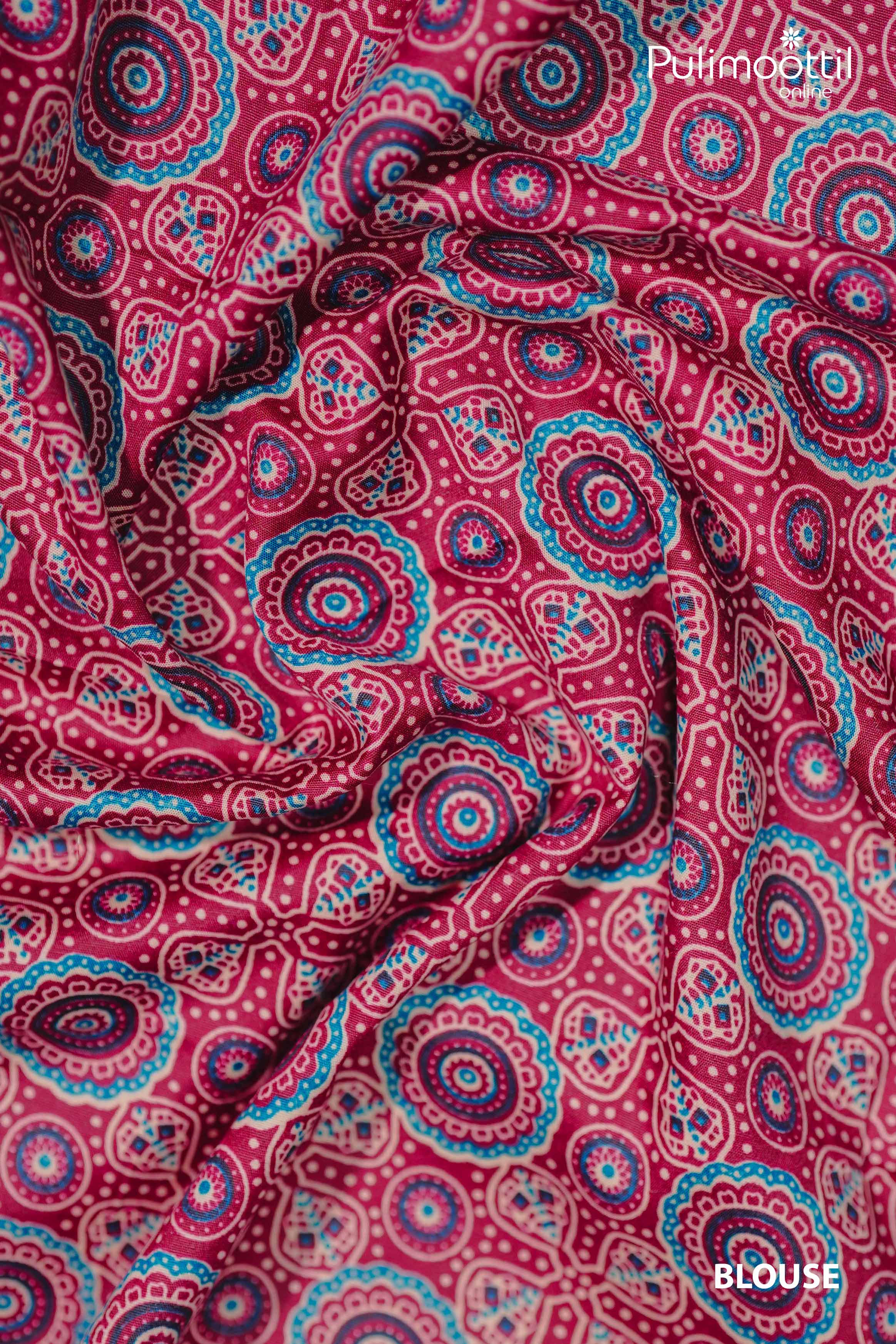 Close-up of maroon Ajrakh printed blouse fabric with intricate circular motifs in blue and beige.
