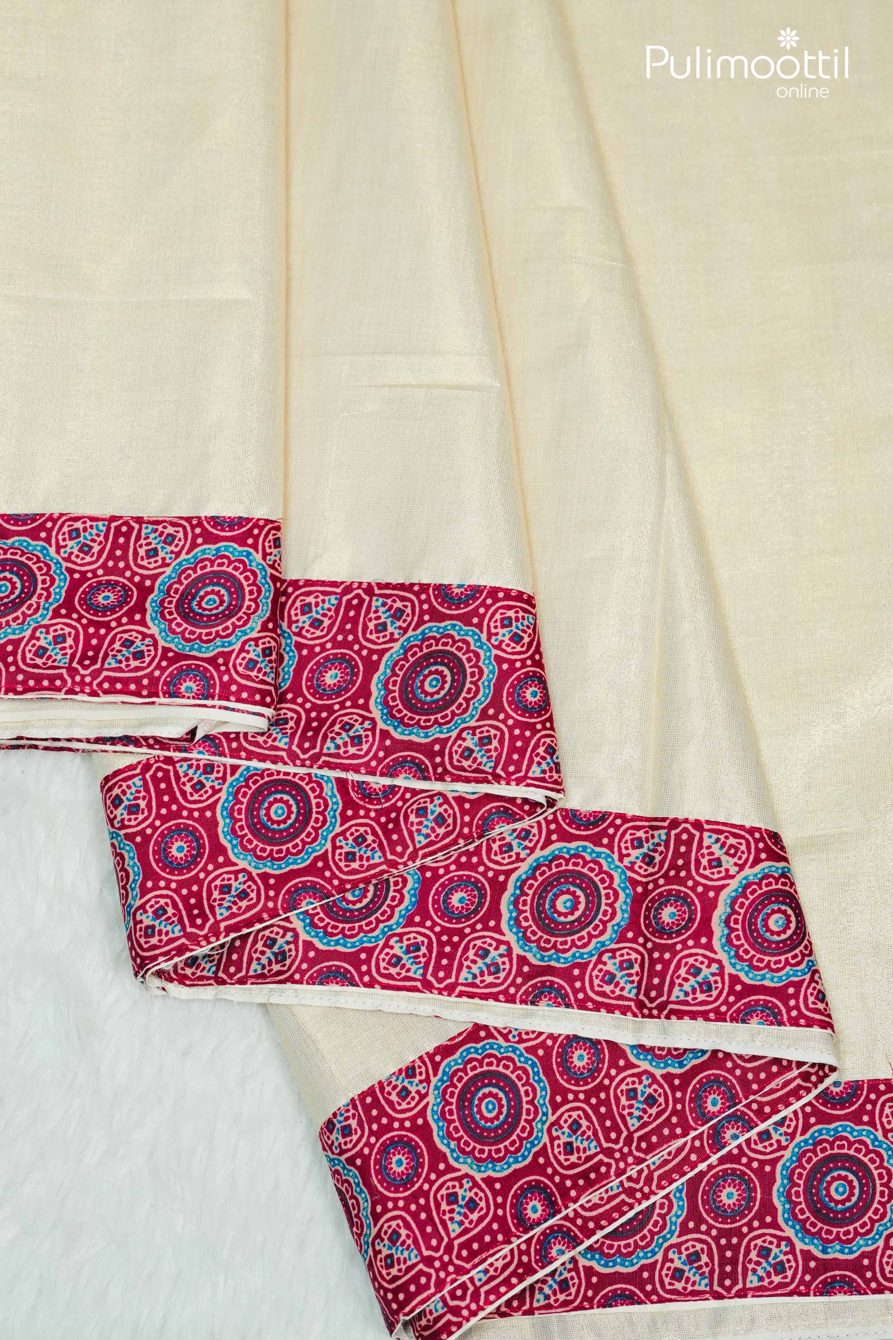 Golden tissue saree with vibrant maroon Ajrakh printed border, displayed flat to showcase intricate design.