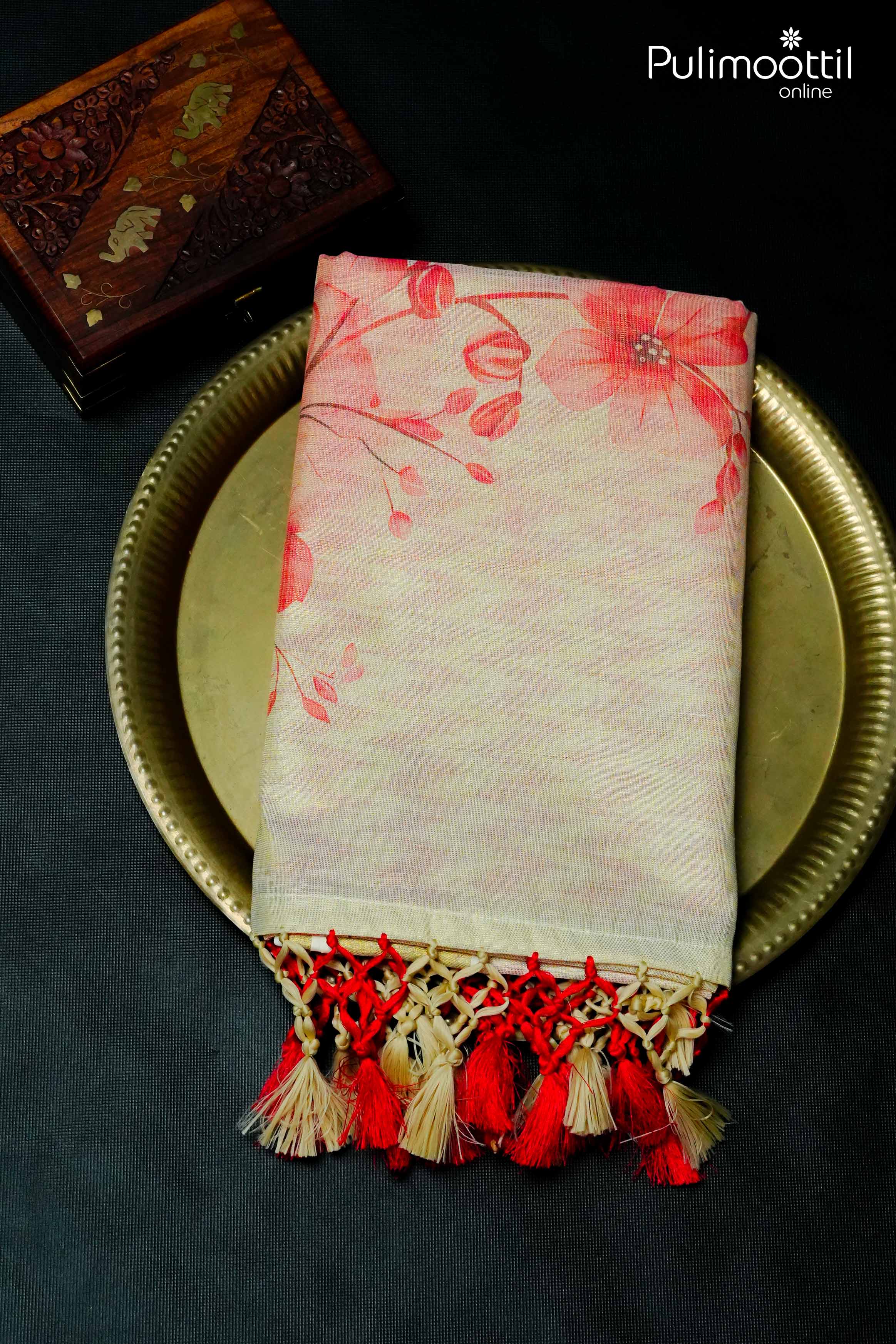 Folded golden tissue saree with red floral print and handcrafted tassels in red and beige – Pulimoottil Silks