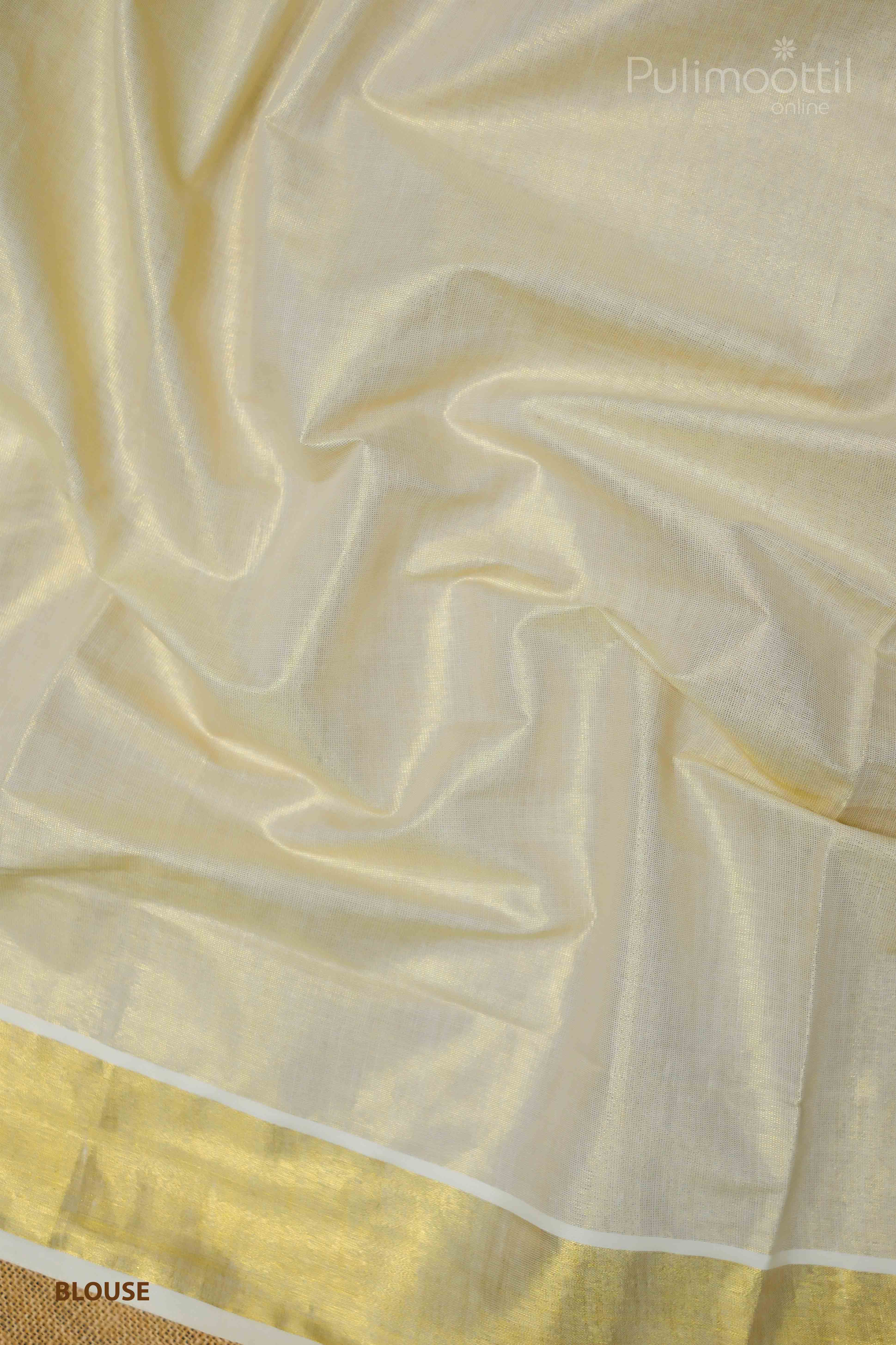 Cream‑gold Kerala tissue saree blouse piece laid flat, showcasing a shimmering golden kasavu strip and smooth tissue silk texture.