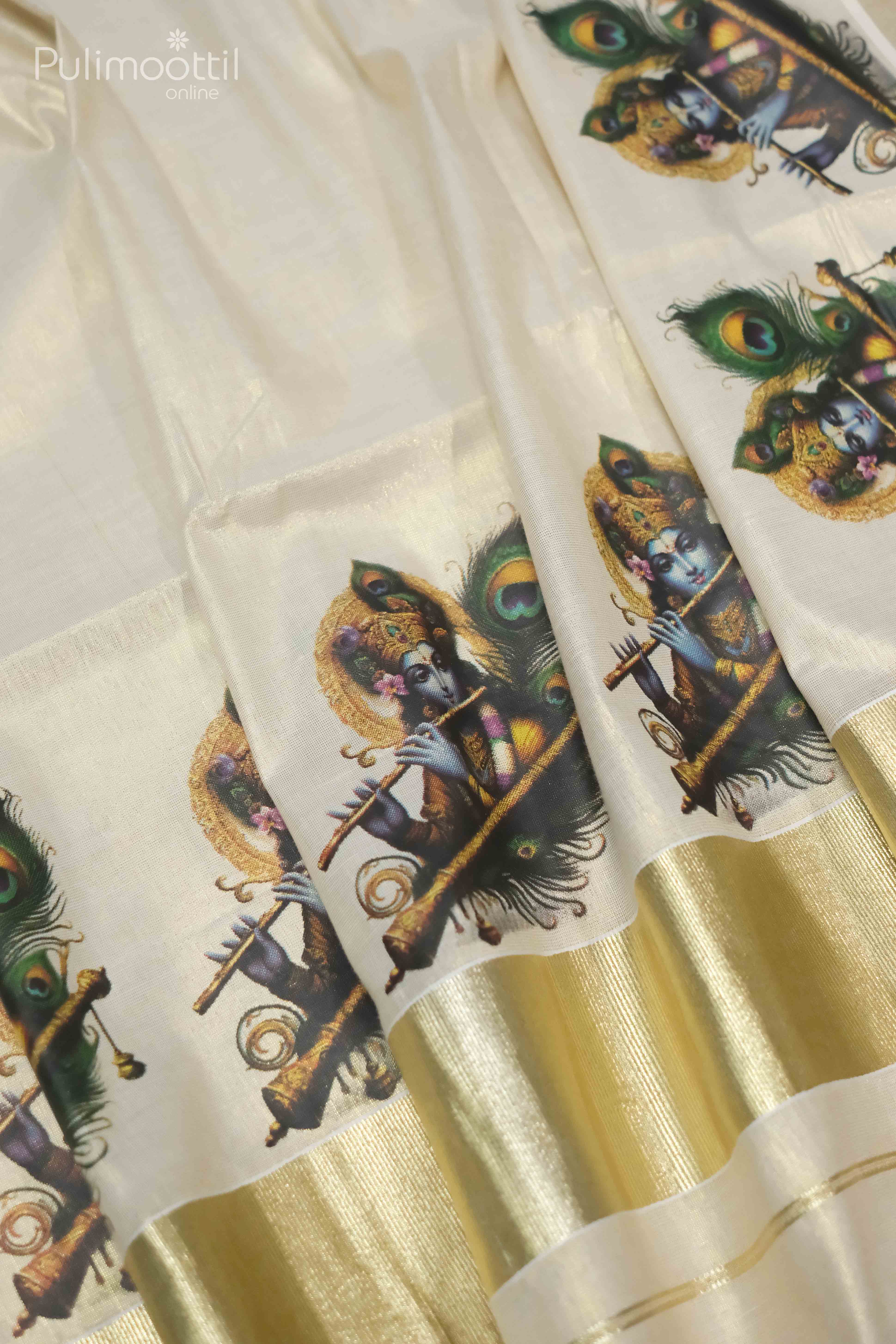 Close-up of golden tissue Kerala saree featuring repeated Krishna print with flute and peacock feather motifs, complemented by a broad golden kasavu border