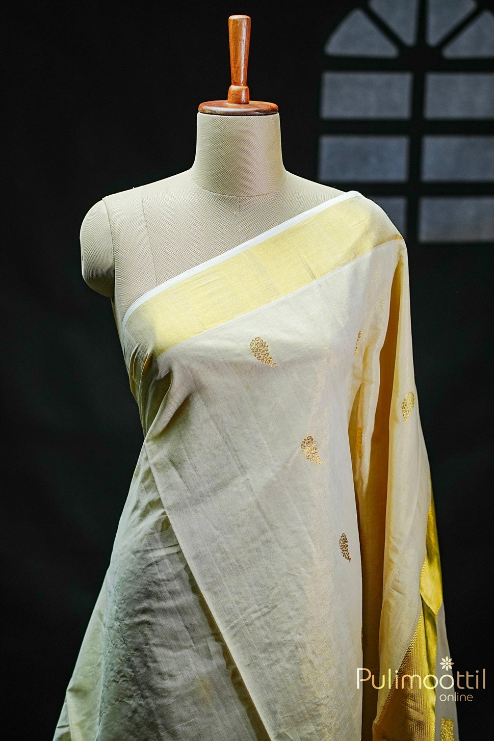 Golden Tissue Kerala Traditional Handloom Saree with golden zari floral buttas and a delicate tissue border, elegantly draped.