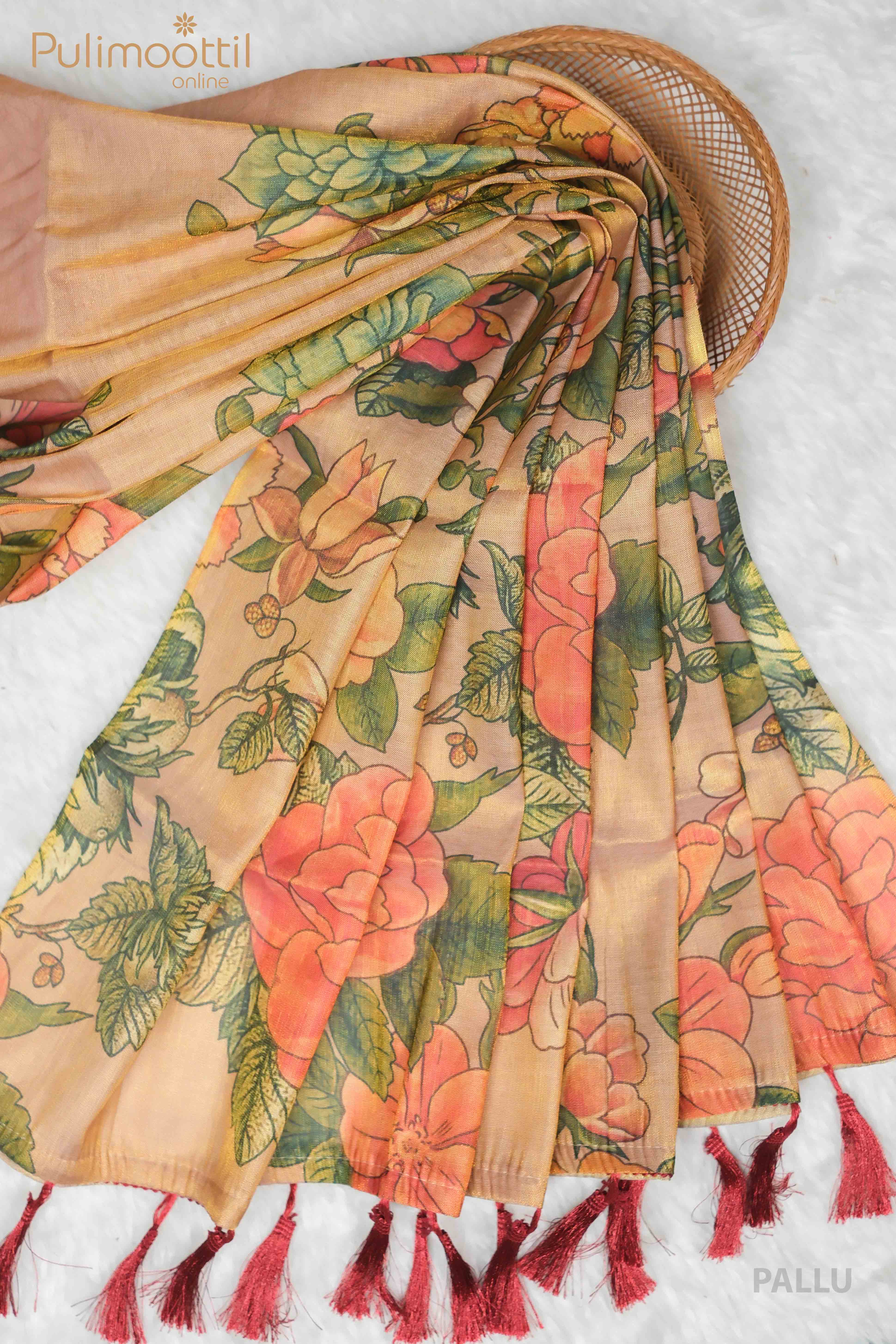 Golden Tissue Onam Kerala Traditional Set Saree featuring a floral digital print with vibrant orange flowers and green leaves. The pallu is elegantly draped with red tassels at the ends, highlighting the intricate design and vibrant colors.