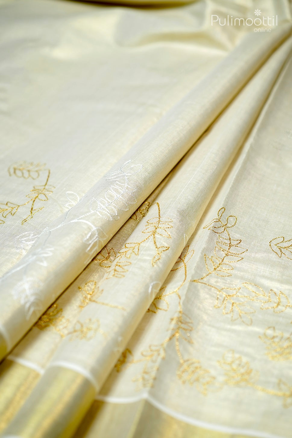 Golden tissue Kerala saree with plain body and delicate floral thread work near the tissue border