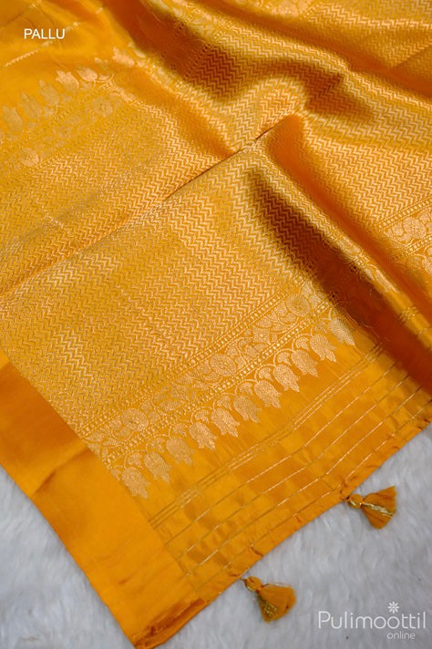 Pallu of Golden Yellow Mango Saree with Geometric Pattern and Zari Floral Design, Featuring Tassels on the End.