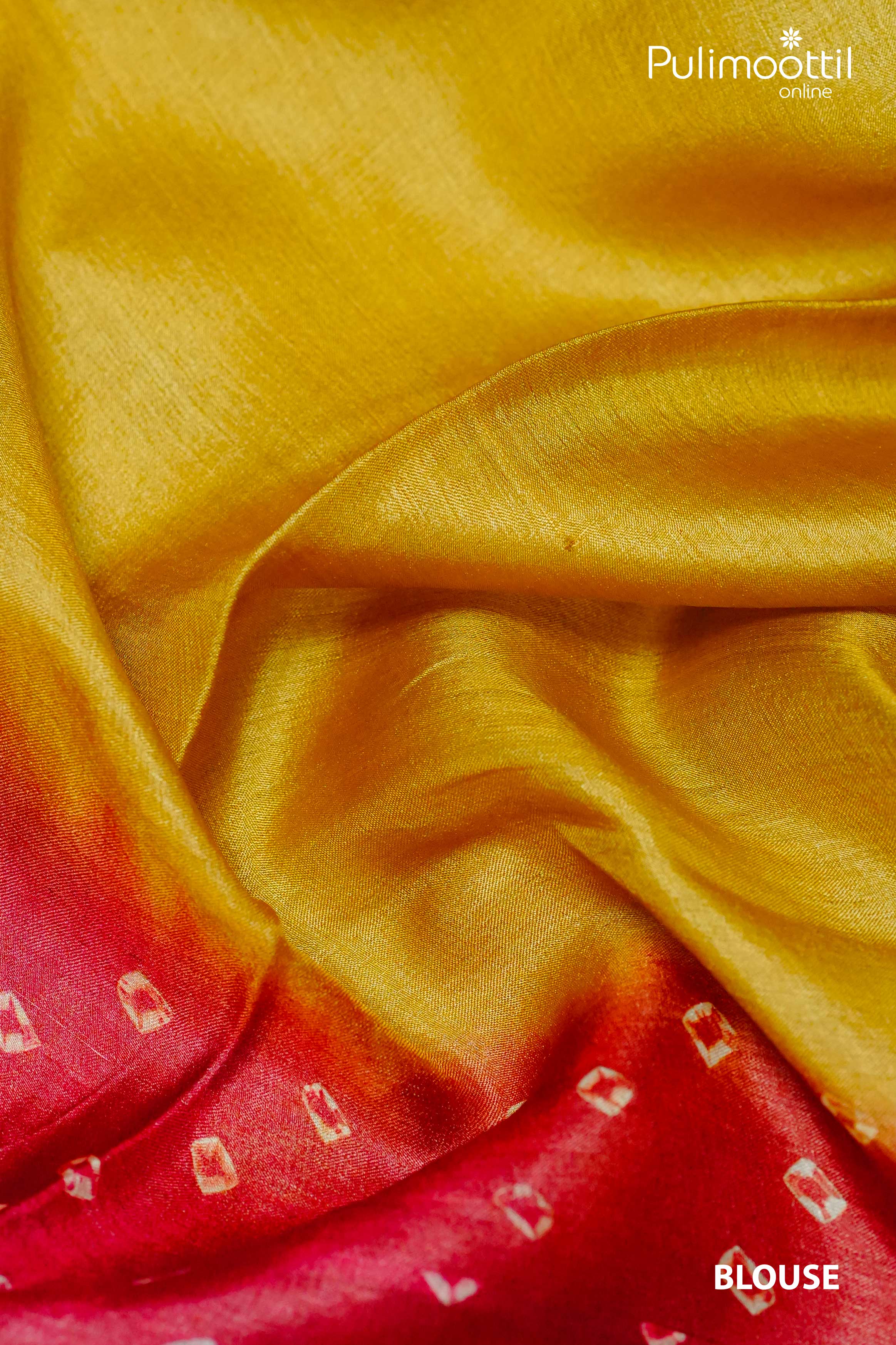 Golden yellow tussar silk blouse fabric with a red Chungidi-style border, featuring small white tie-dye motifs and a smooth silk texture.