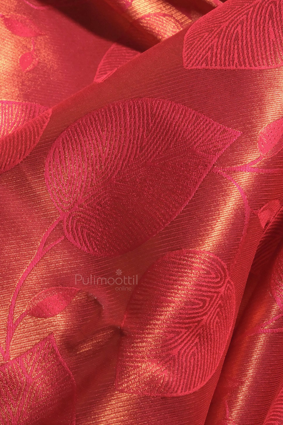 Full-length view of the model seated elegantly in the Kanchipuram bridal saree, with gold zari work prominently displayed.