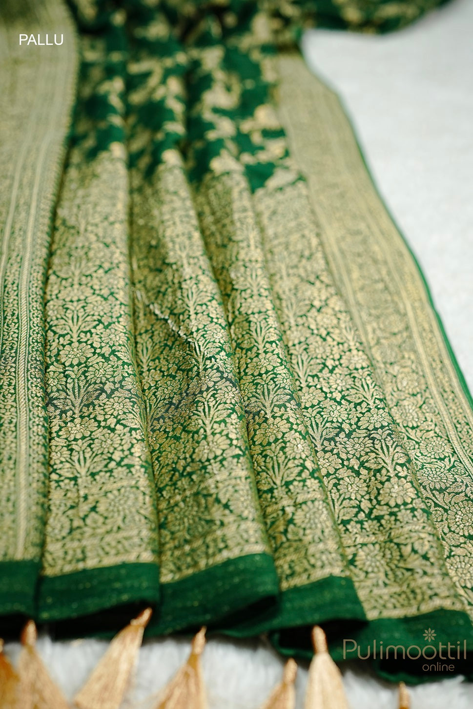 Pallu of Green Colour Pure Georgette Banarasi Saree with Golden Floral Design and Tassels