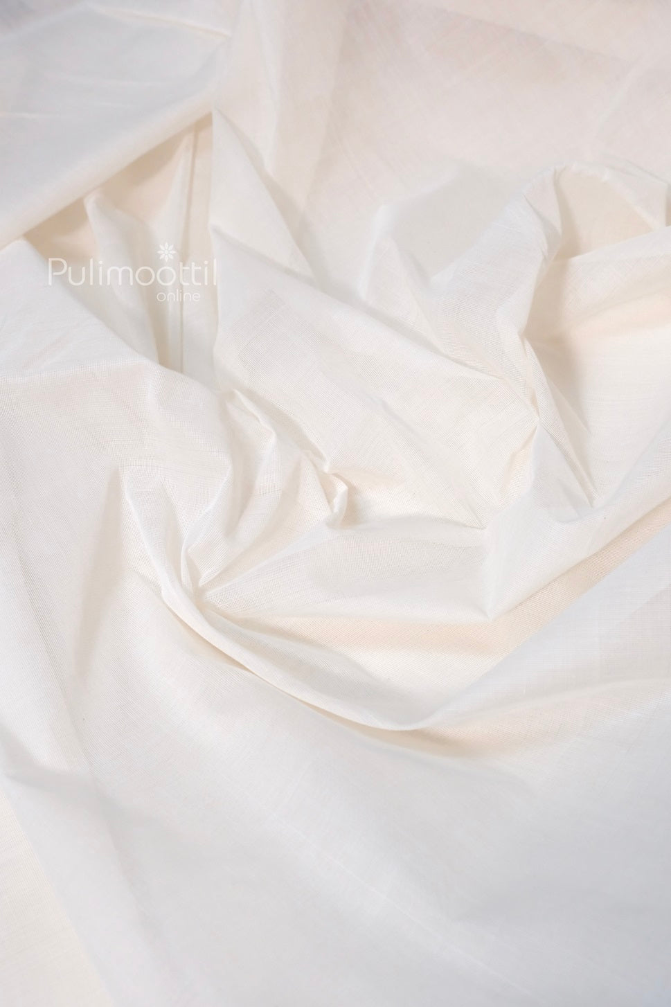 Soft white handloom cotton fabric draped with gentle folds, ideal for sarees or traditional wear