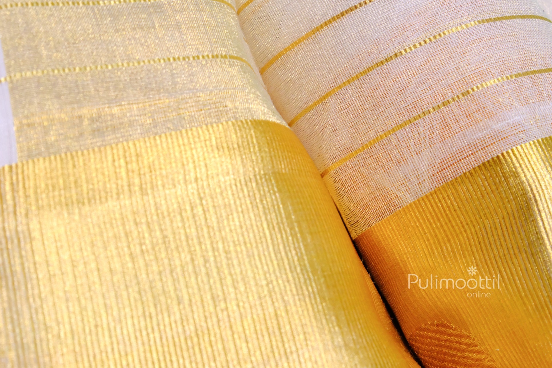 Close-up of elegant golden zari weave on a Kerala Kasavu saree with vertical stripe detailing, showcasing intricate silk texture.