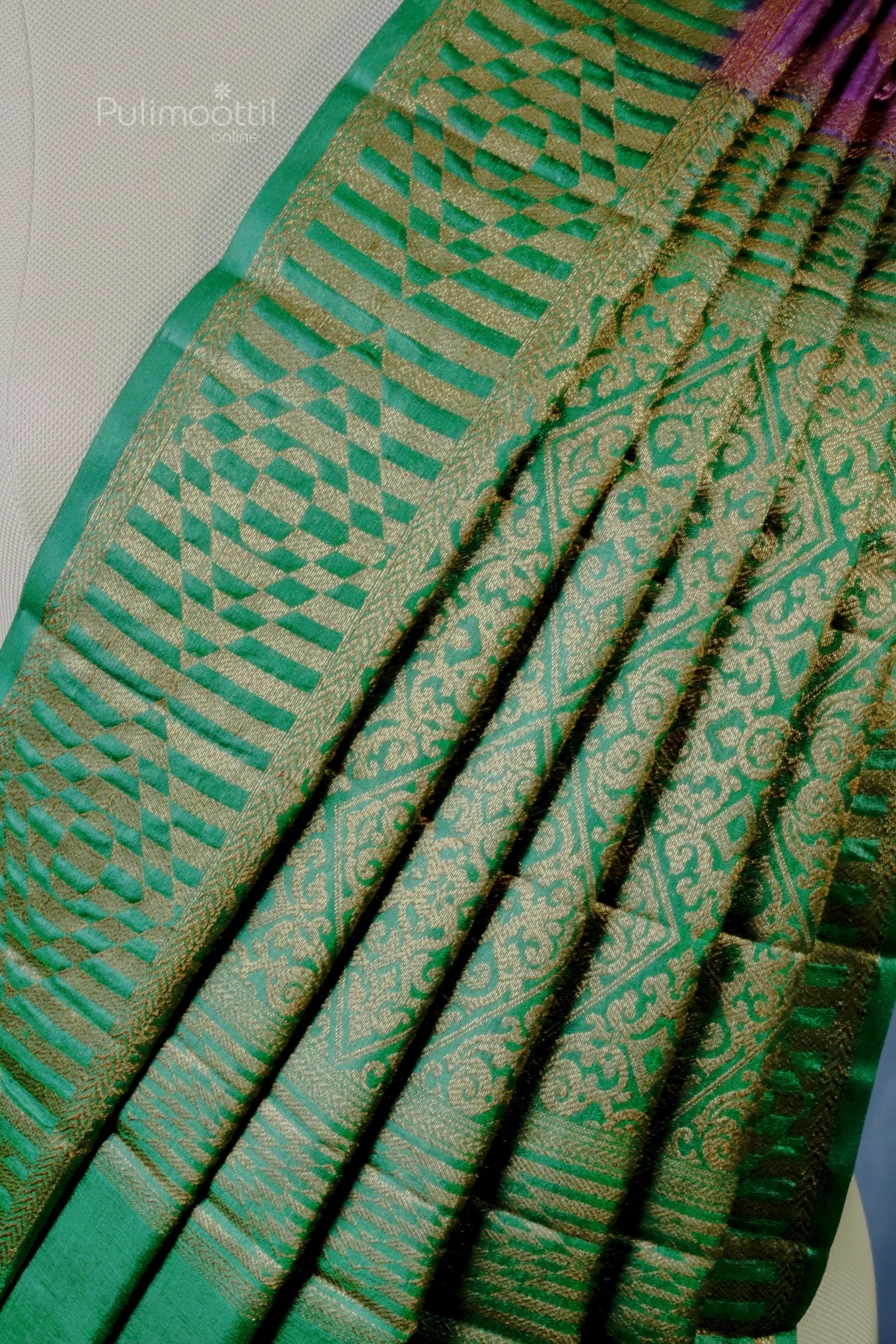 Detailed view of the green zari pallu with rich brocade pattern from the Iris purple silk saree