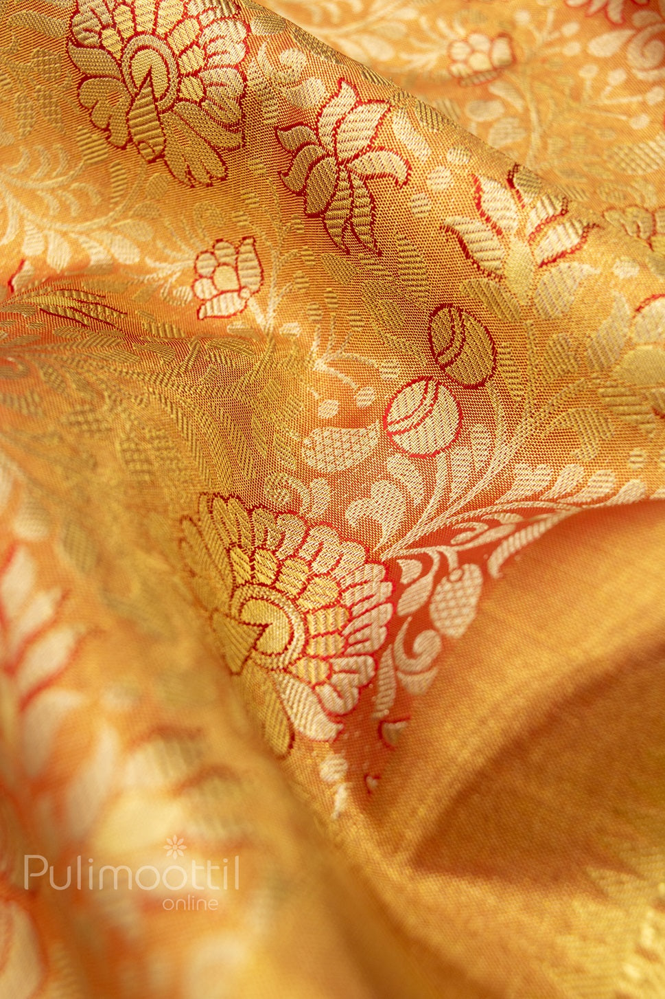 Kanchipuram tissue silk saree with golden zari floral and leaf motifs, traditional contrast border – ideal for bridal and festive occasions