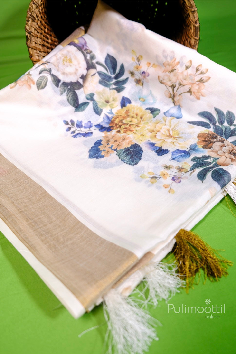 Folded Kerala tissue saree with beautiful floral digital print and soft golden border, featuring stylish tassels, ideal for Onam sarees collection online.