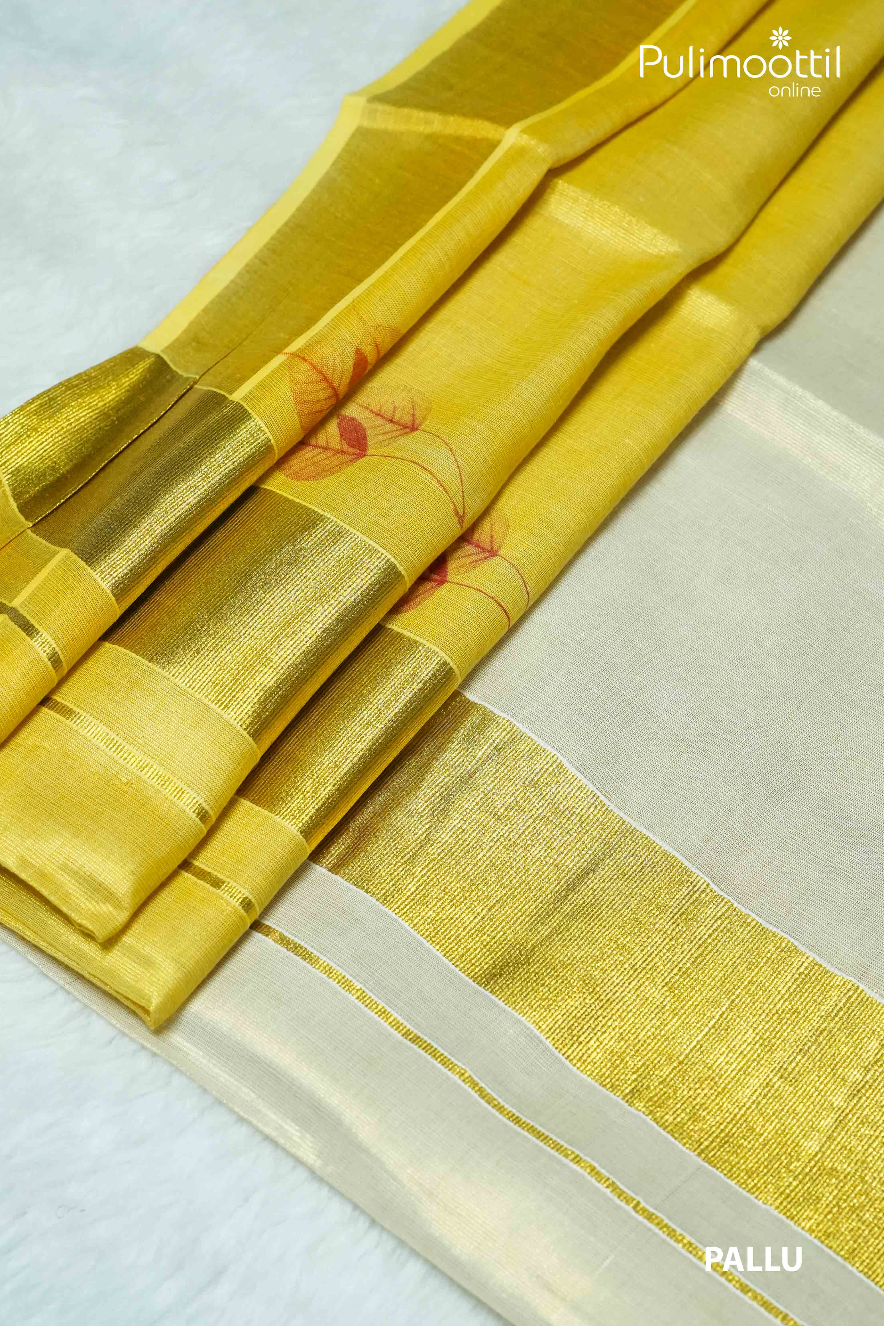 Pallu of Kerala golden tissue saree with golden zari border and red leaf motifs, laid on white surface.